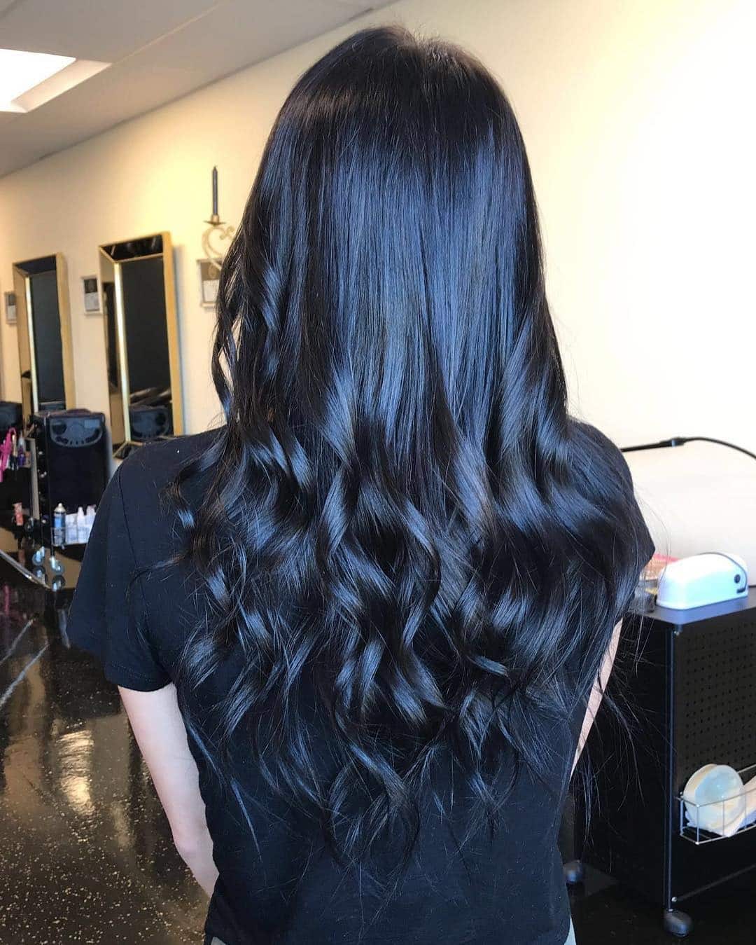 7. Elegant Curls with Subtle Blue Glow - Blue Black Hair Color