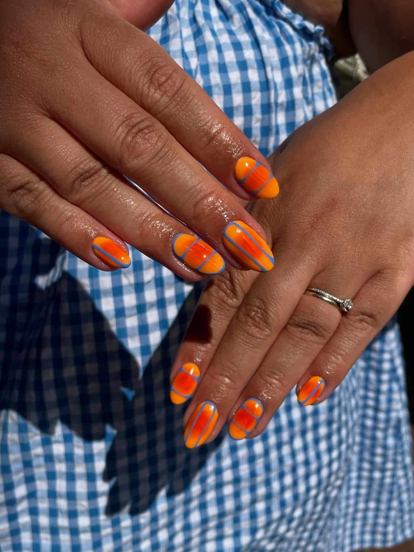 19. Vivid Orange and Blue Graphic Nails - june nail ideas