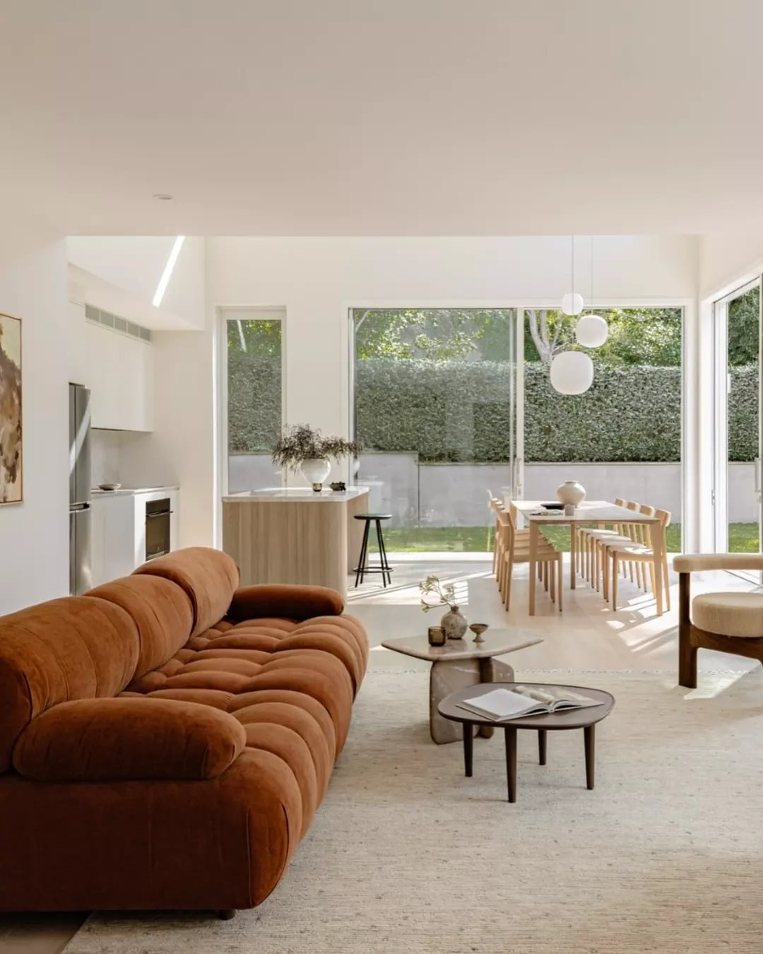 6. Sunlit Simplicity with Plush Comfort - light brown sofa living room ideas