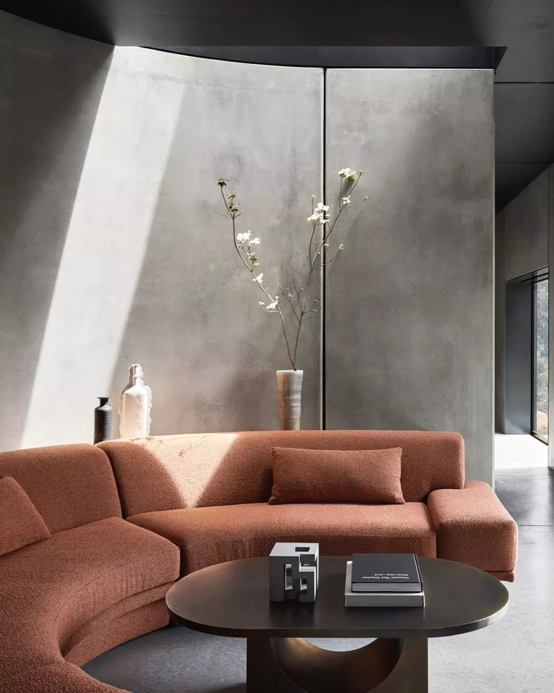 10. Sculptural Modernity with Warm Curves - light brown sofa living room ideas