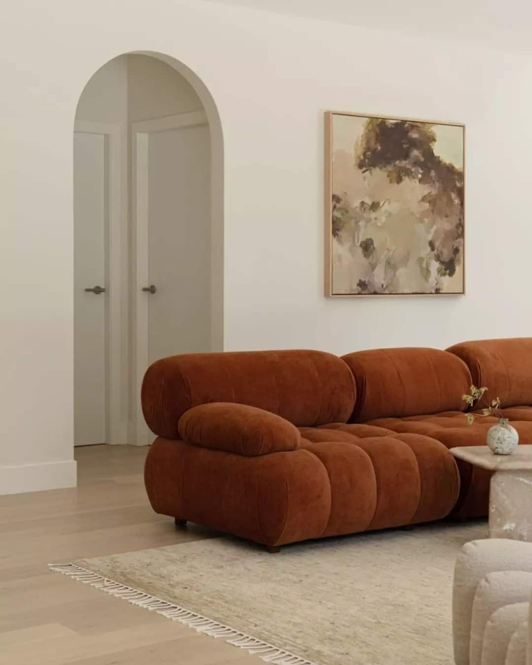 13. Playful Curves in Earthy Upholstery - light brown sofa living room ideas