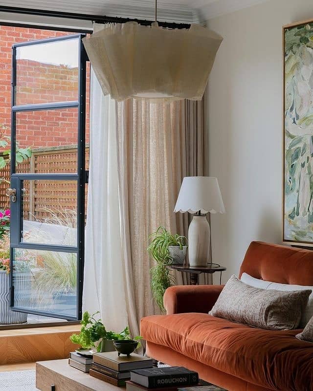 14. Indoor-Outdoor Harmony with Terracotta Tones - light brown sofa living room ideas