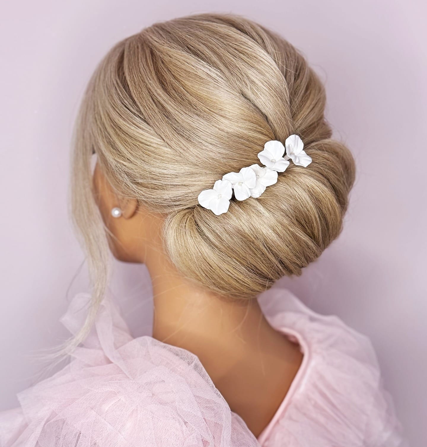 5. Elegant French Twist with White Floral Accent on Blonde Hair - Cute Hairstyles