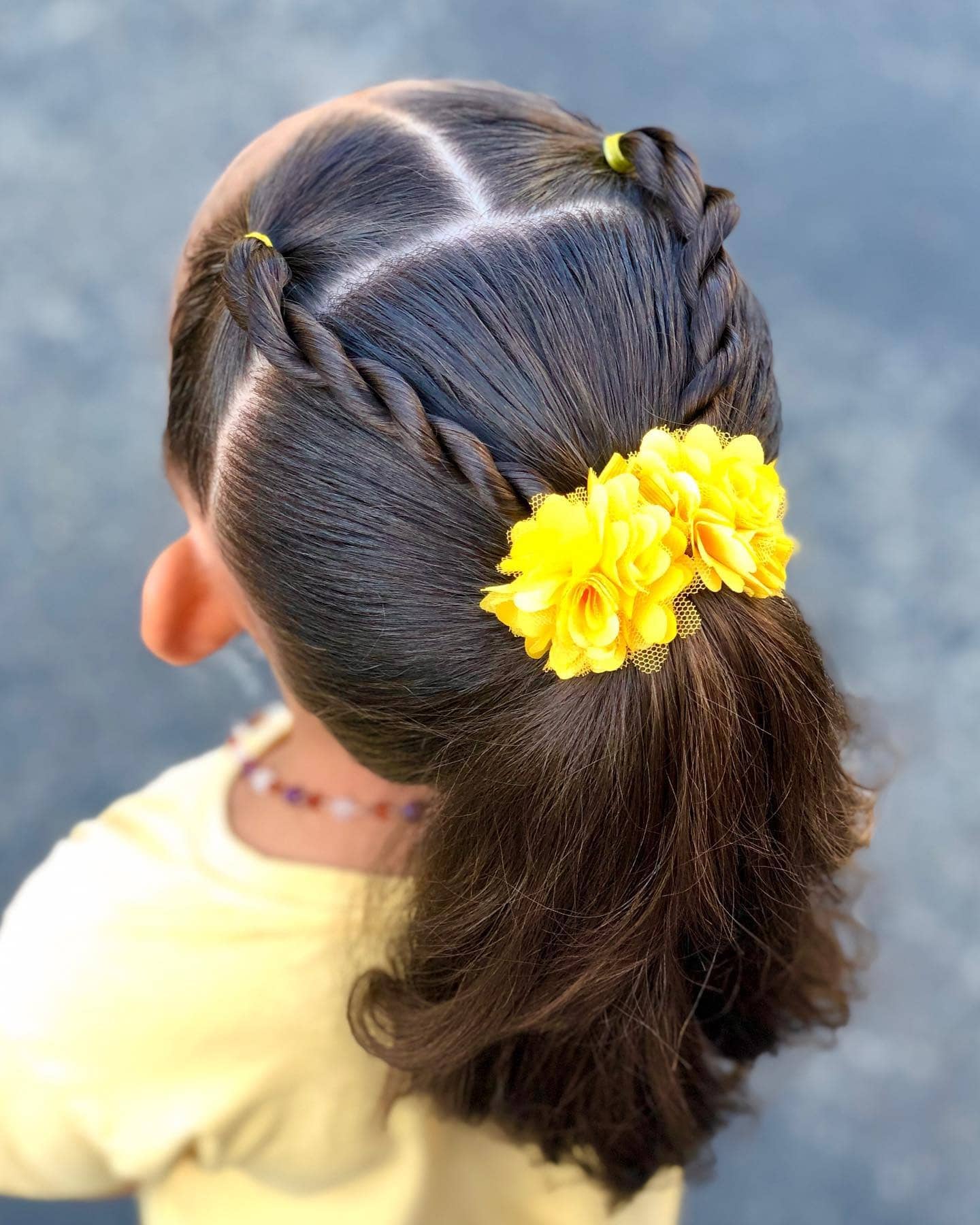 6. Twisted Ponytail with Yellow Floral Clip on Dark Brown Hair - Cute Hairstyles