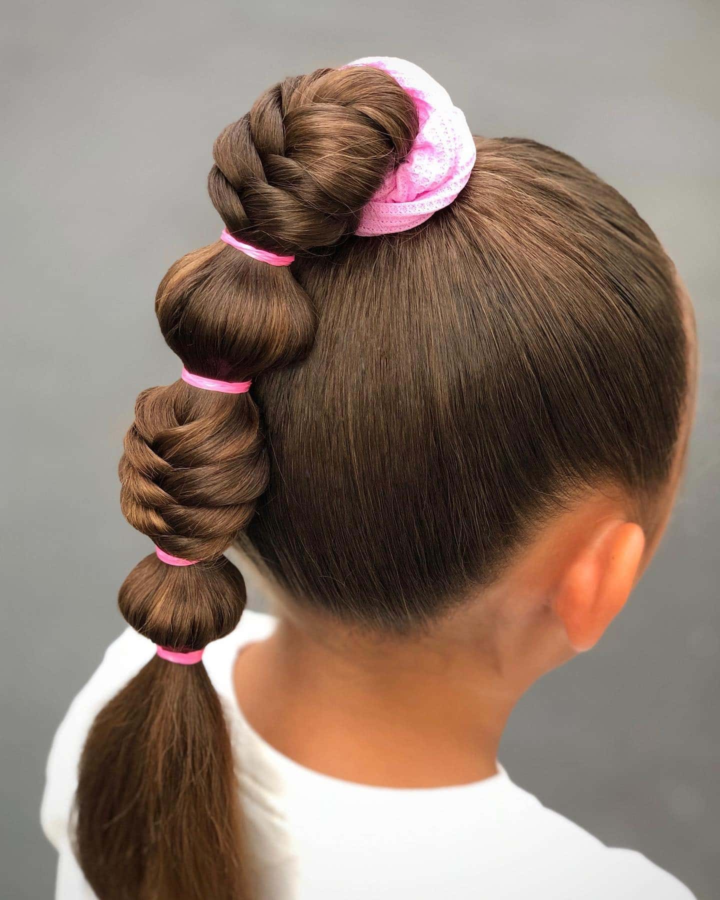 8. Braided Bubble Ponytail with Pink Scrunchie on Brunette Hair - Cute Hairstyles