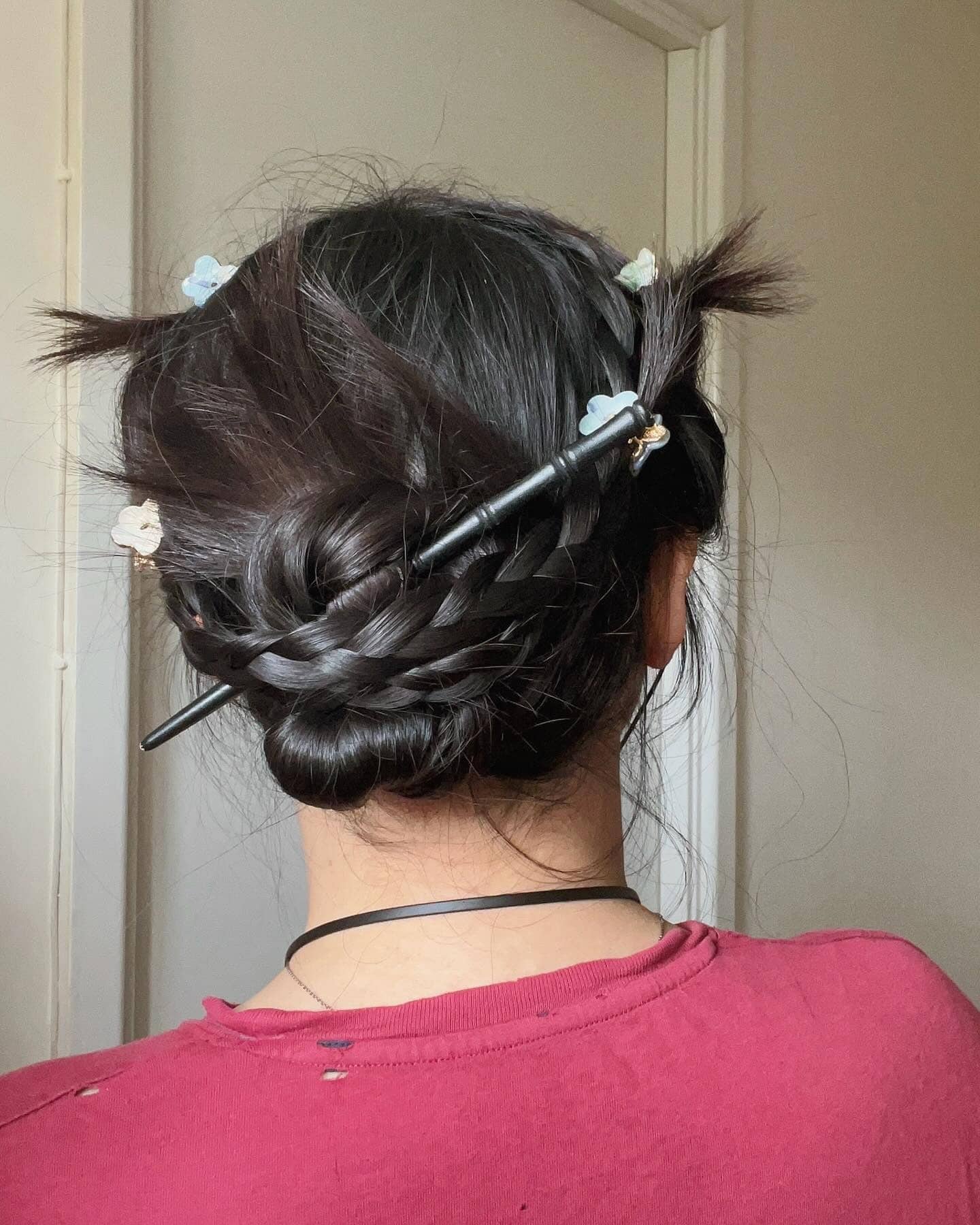 15. Braided Low Bun with Butterfly Clips on Dark Brown Hair - Cute Hairstyles