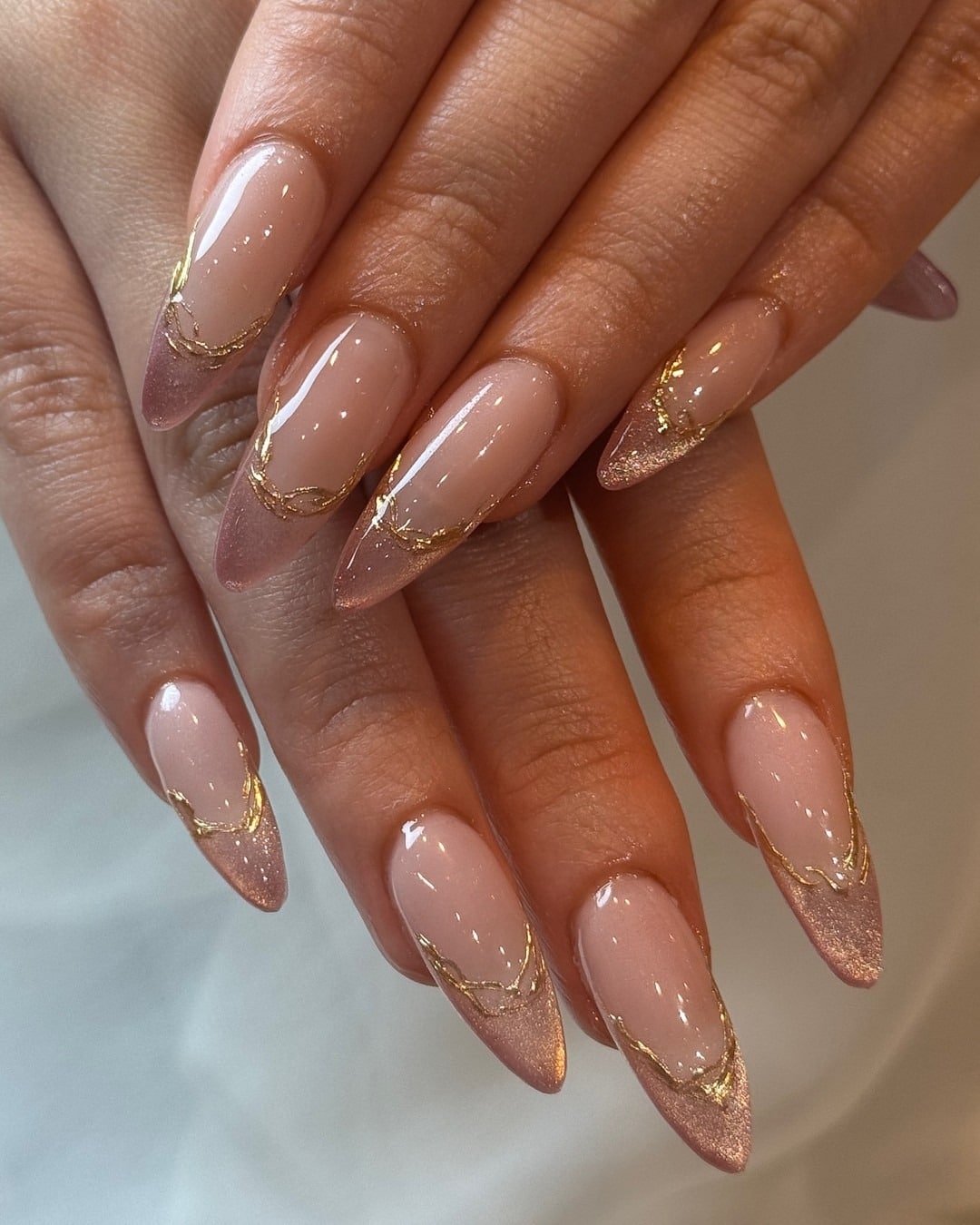 22. Rose Gold French with Metallic Veins - medium length nail ideas