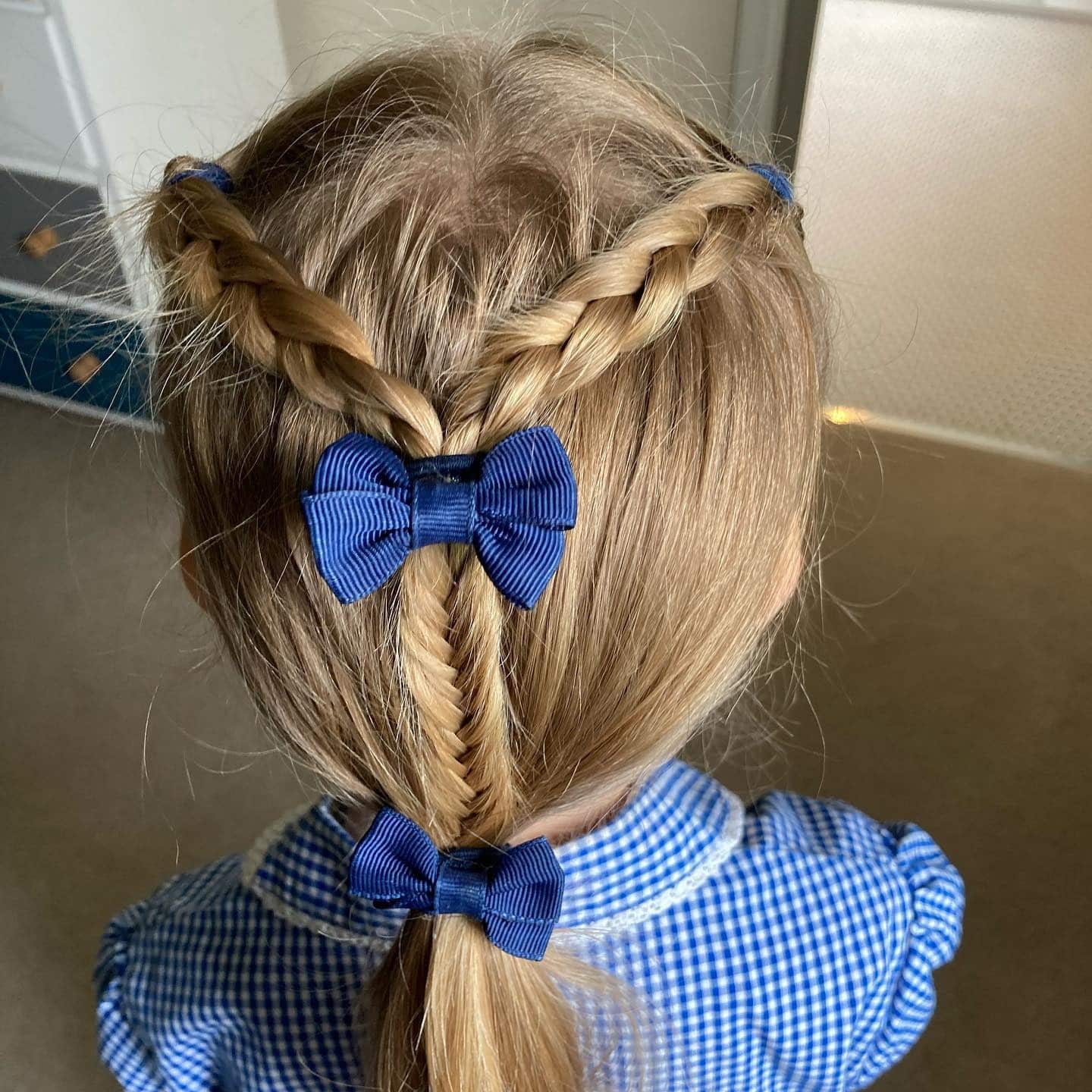 5. Fishtail Pony with Dual Bows on Blonde Hair - Hairstyles For School