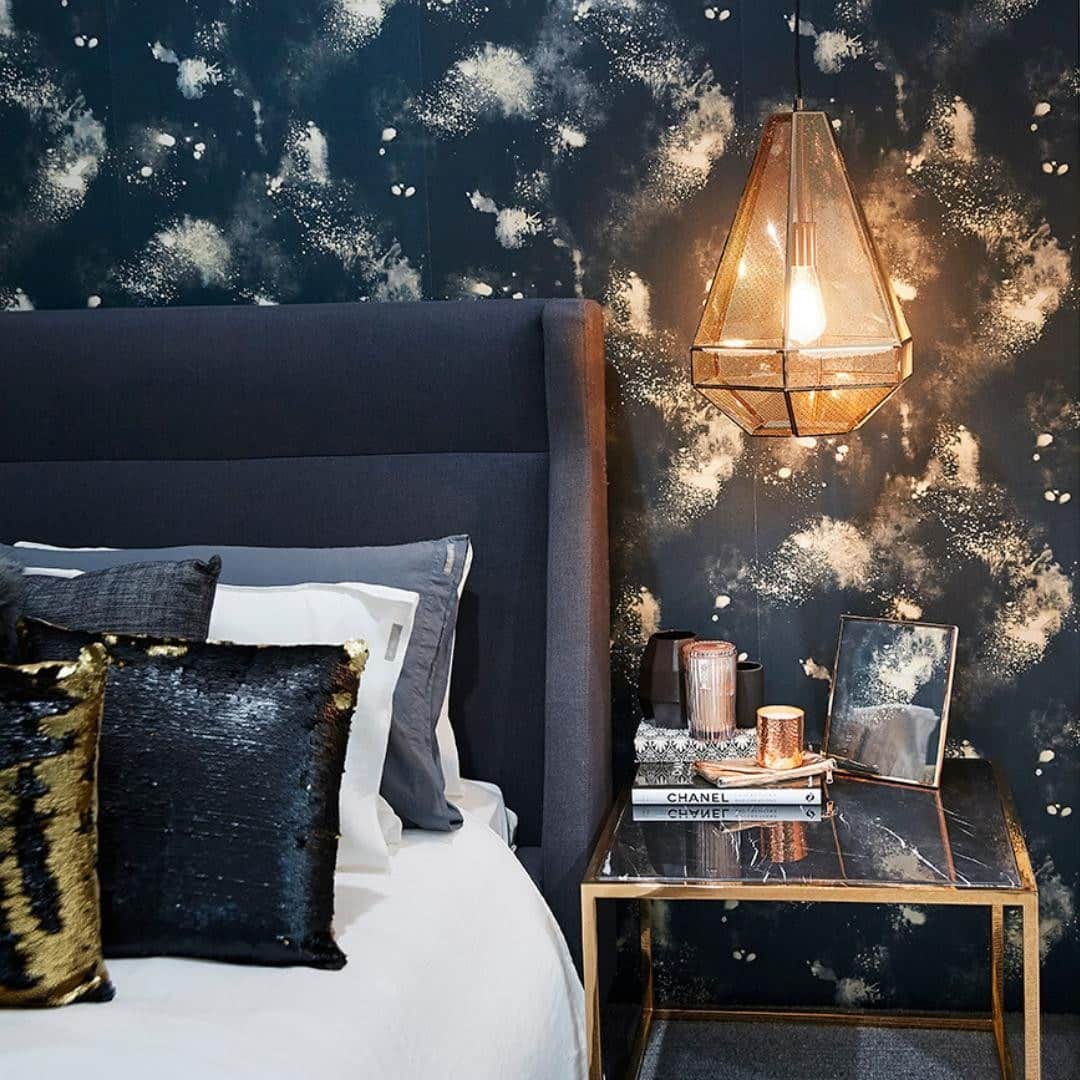 15. Celestial Drama with Statement Lighting - black and gold bedroom ideas