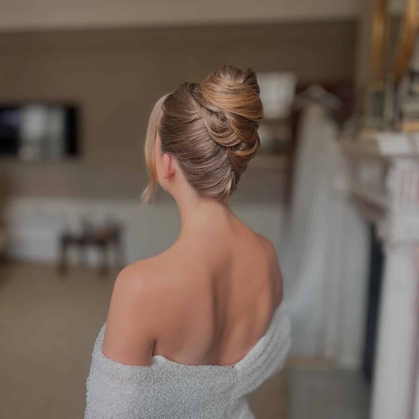 5. Elegant Blonde French Twist with Face-Framing Layers - Wedding Hairstyles