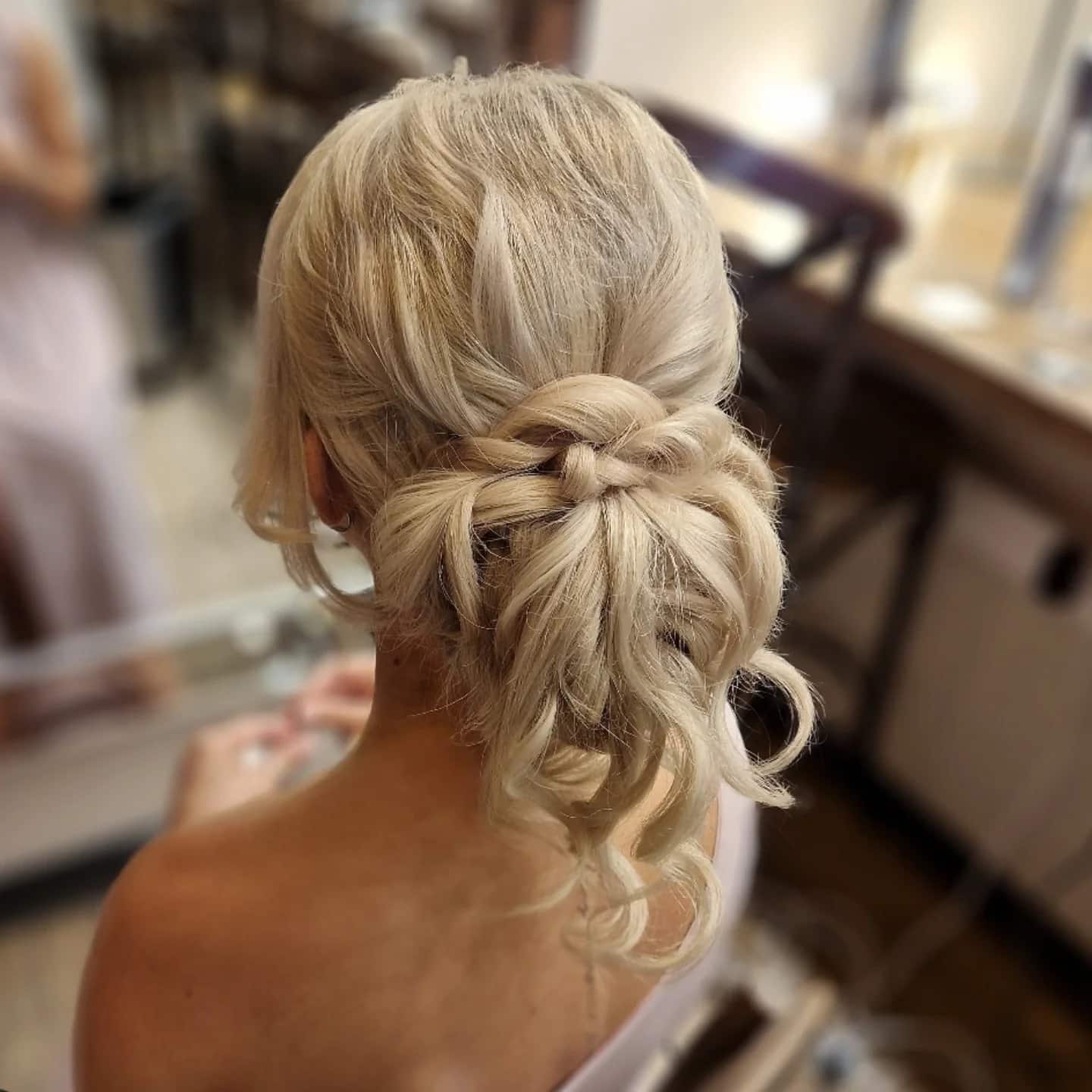 8. Textured Blonde Braided Low Bun - Wedding Hairstyles