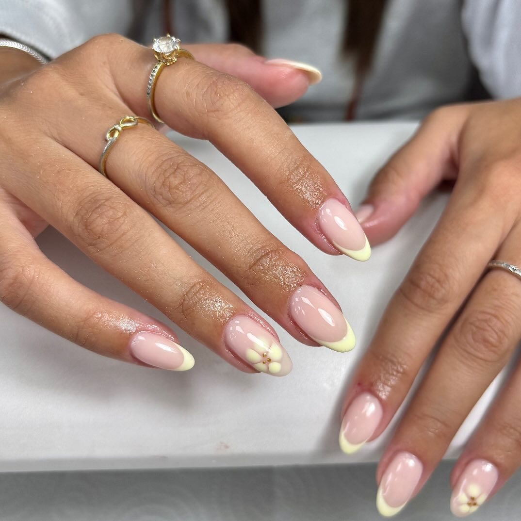 13. Almond French with Soft Yellow Tips and Floral Accent - pink almond nail ideas