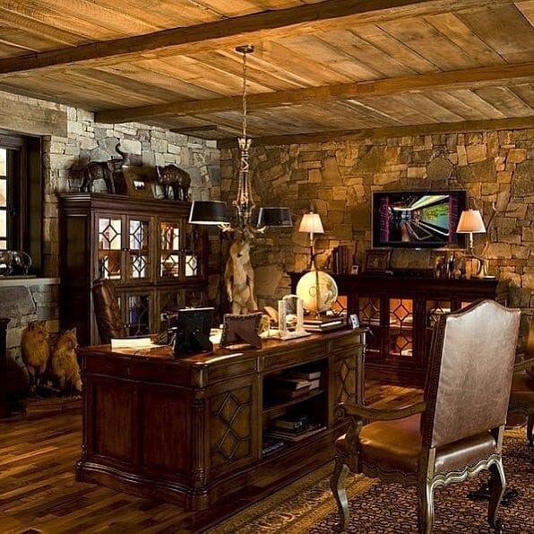 10. Stone-Walled Office with Rich Wood Desk - rustic home office ideas