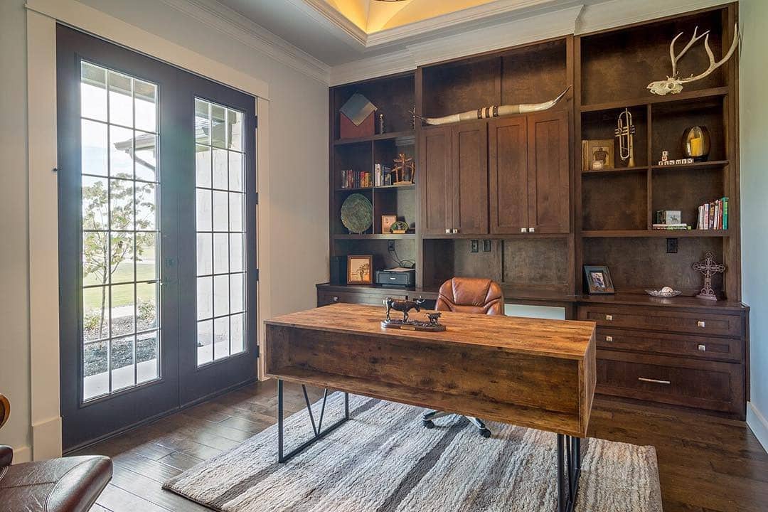 18. Rustic Executive Office with Dark Wood Built-ins - rustic home office ideas