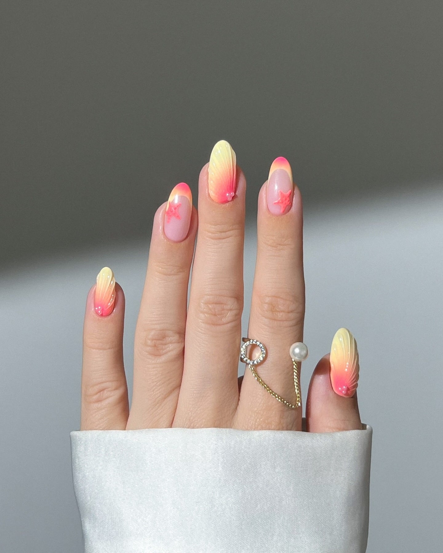 14. Ombre Seashell Elegance - pink and yellow nail ideas