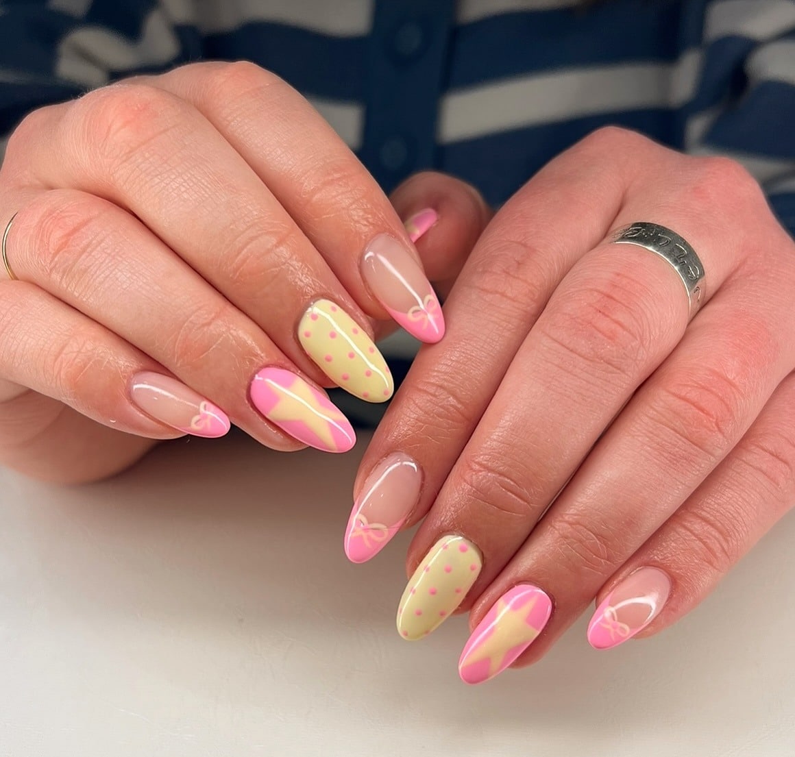 15. Pastel Bow Accents - pink and yellow nail ideas