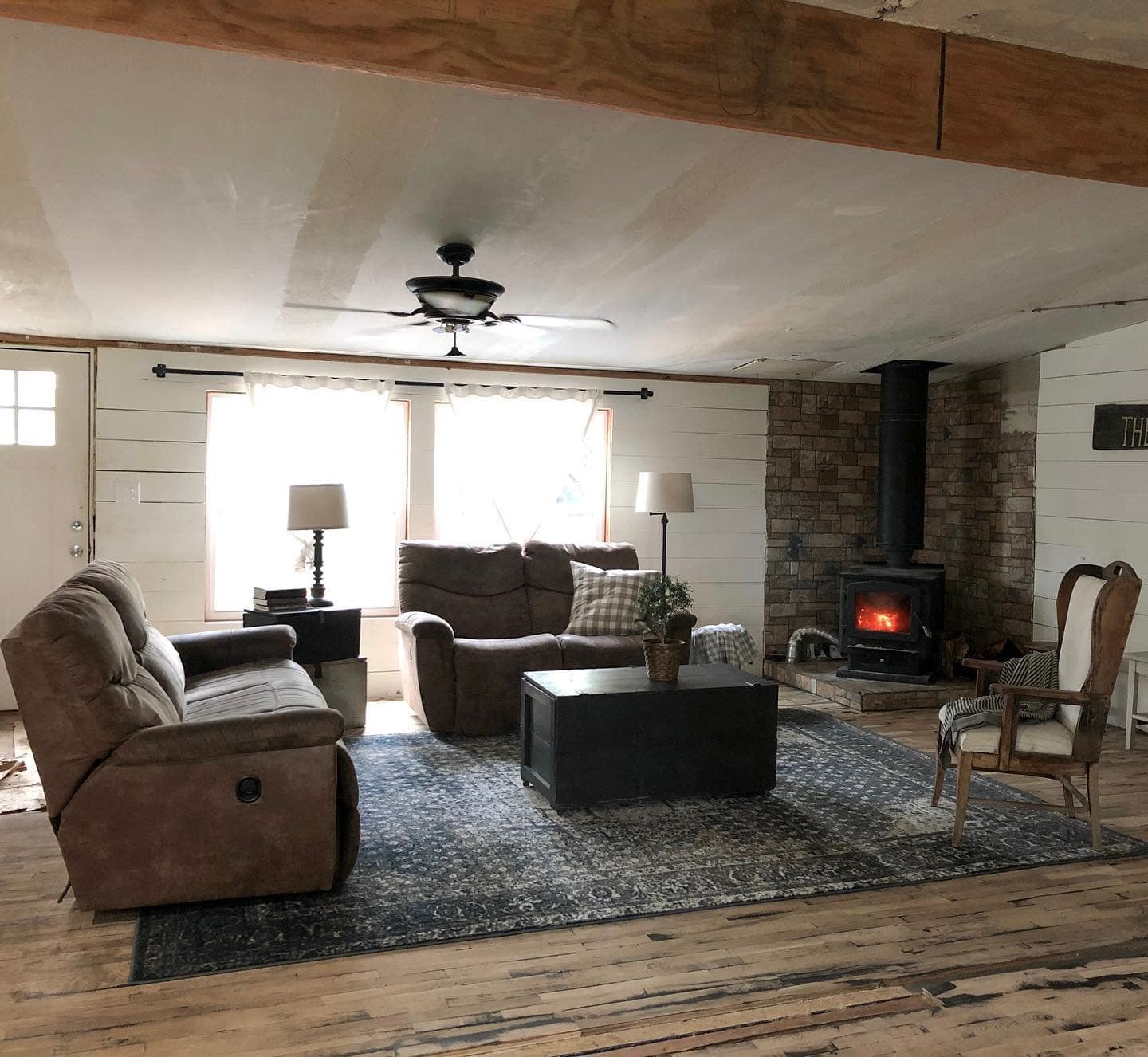 12. Rustic Warmth with Wood Stove - mobile home living room ideas