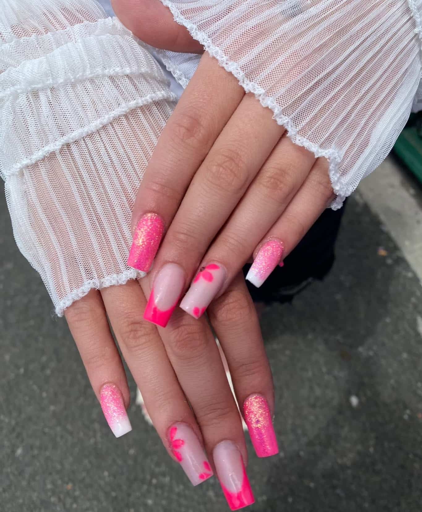 5. Playful Pink Glitter and Floral Accents - pink tip nail ideas