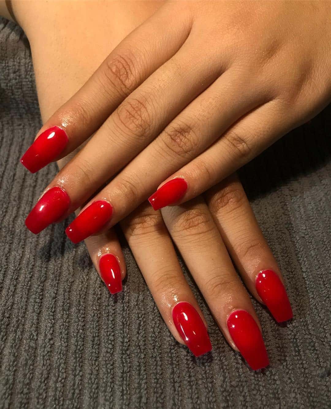 3. High-Shine Ruby Coffin - red coffin nail ideas