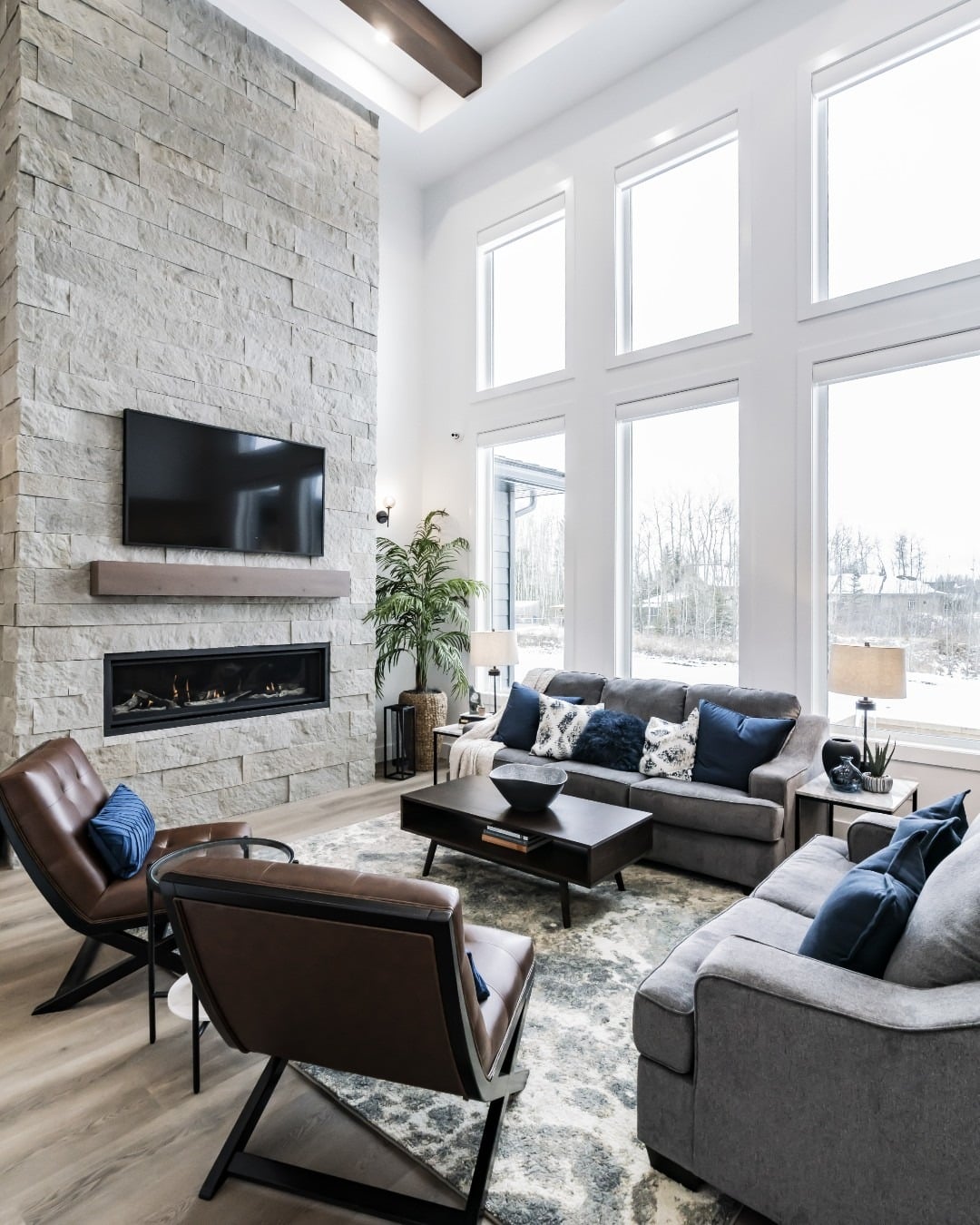 1. Modern Contrast with Soaring Stonework - stone fireplace living room ideas