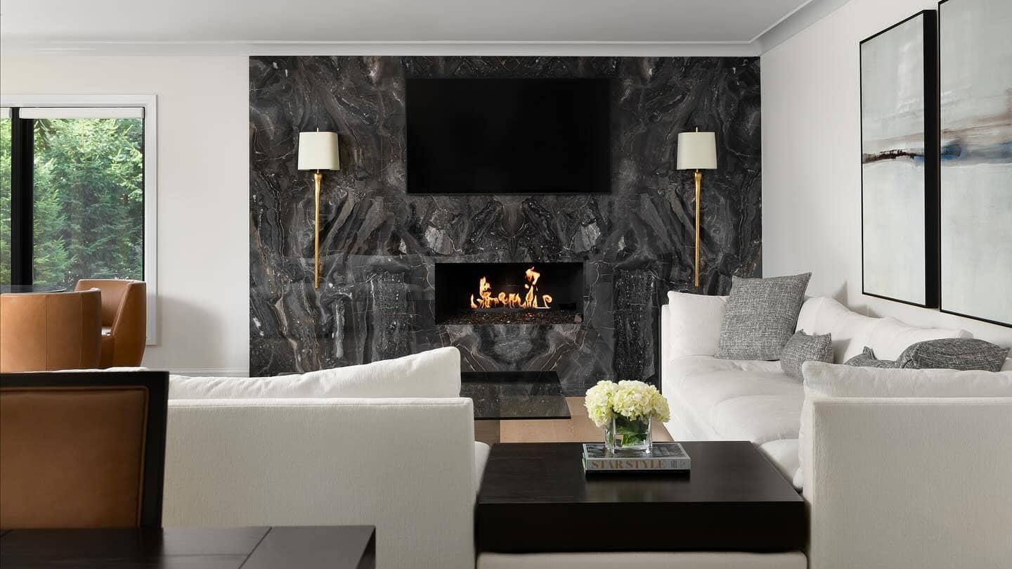 11. Bold Drama with Black Stone - stone fireplace living room ideas