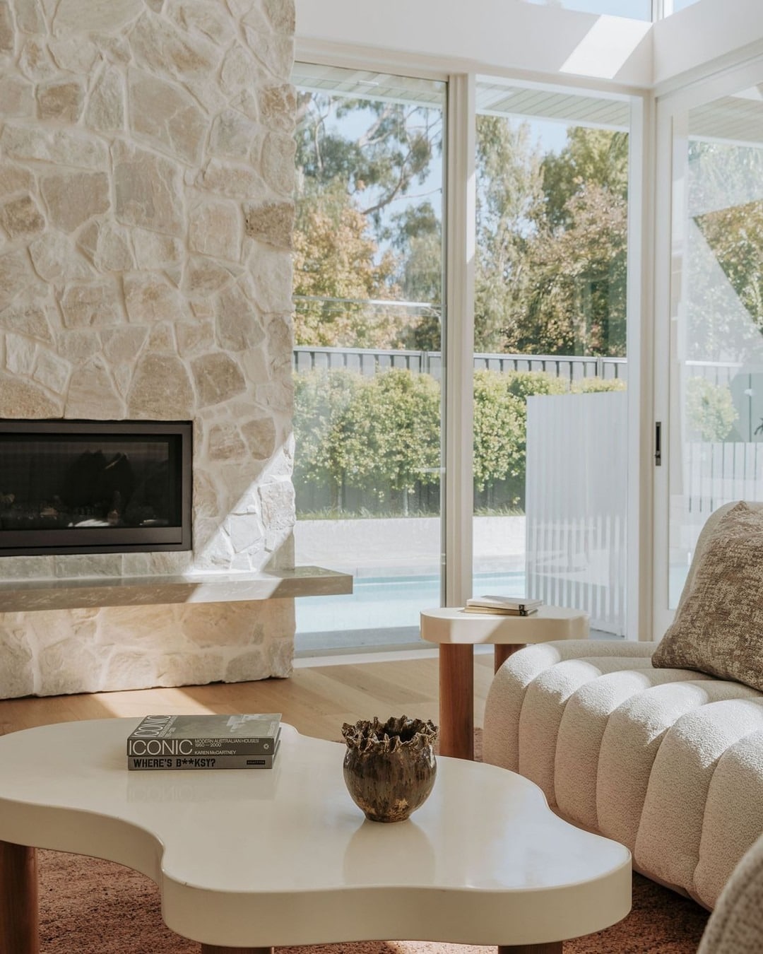 12. Sunlit Warmth with Pale Stone - stone fireplace living room ideas