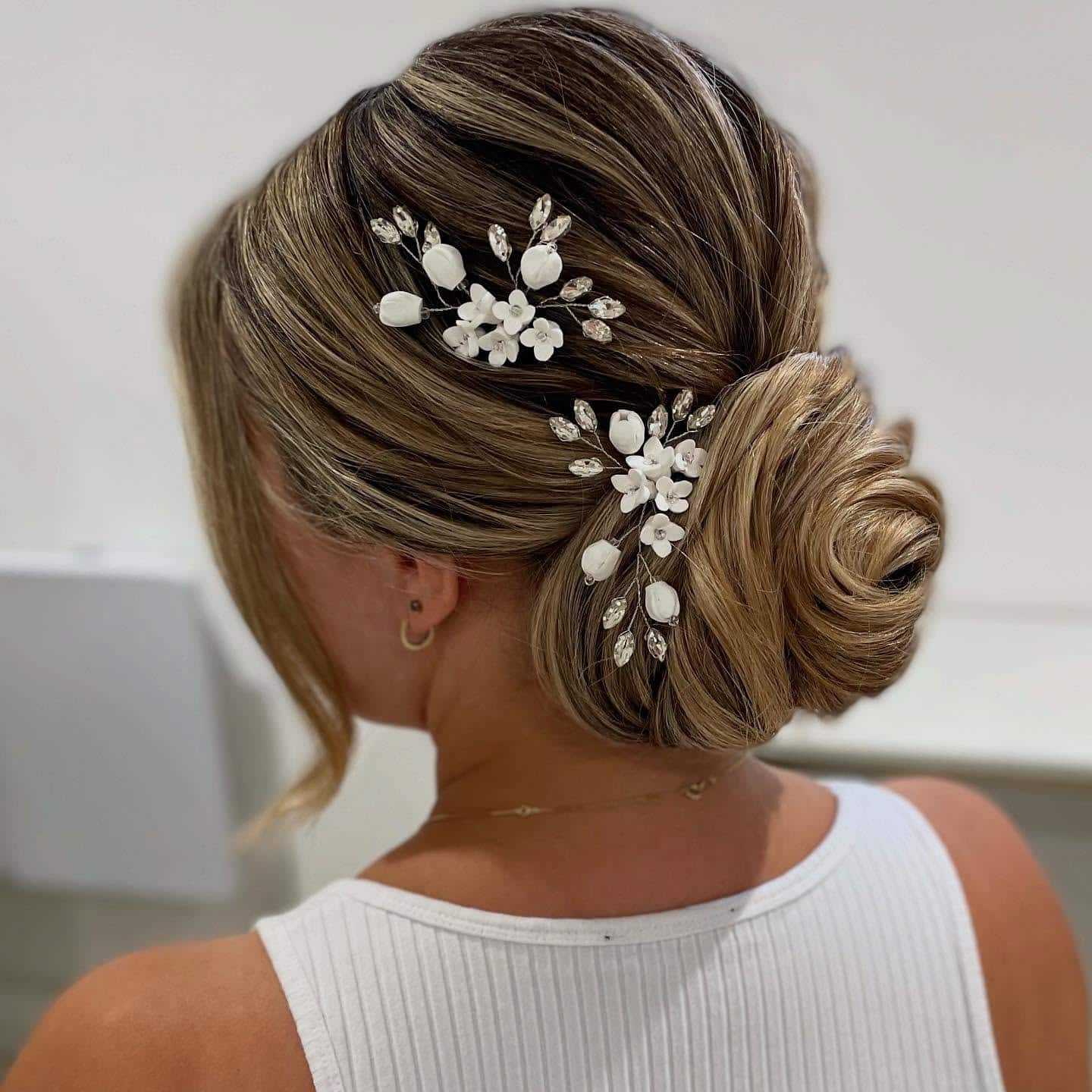 15. Classic Side Bun with Floral Pins β Champagne Blonde - Bride Hairstyles