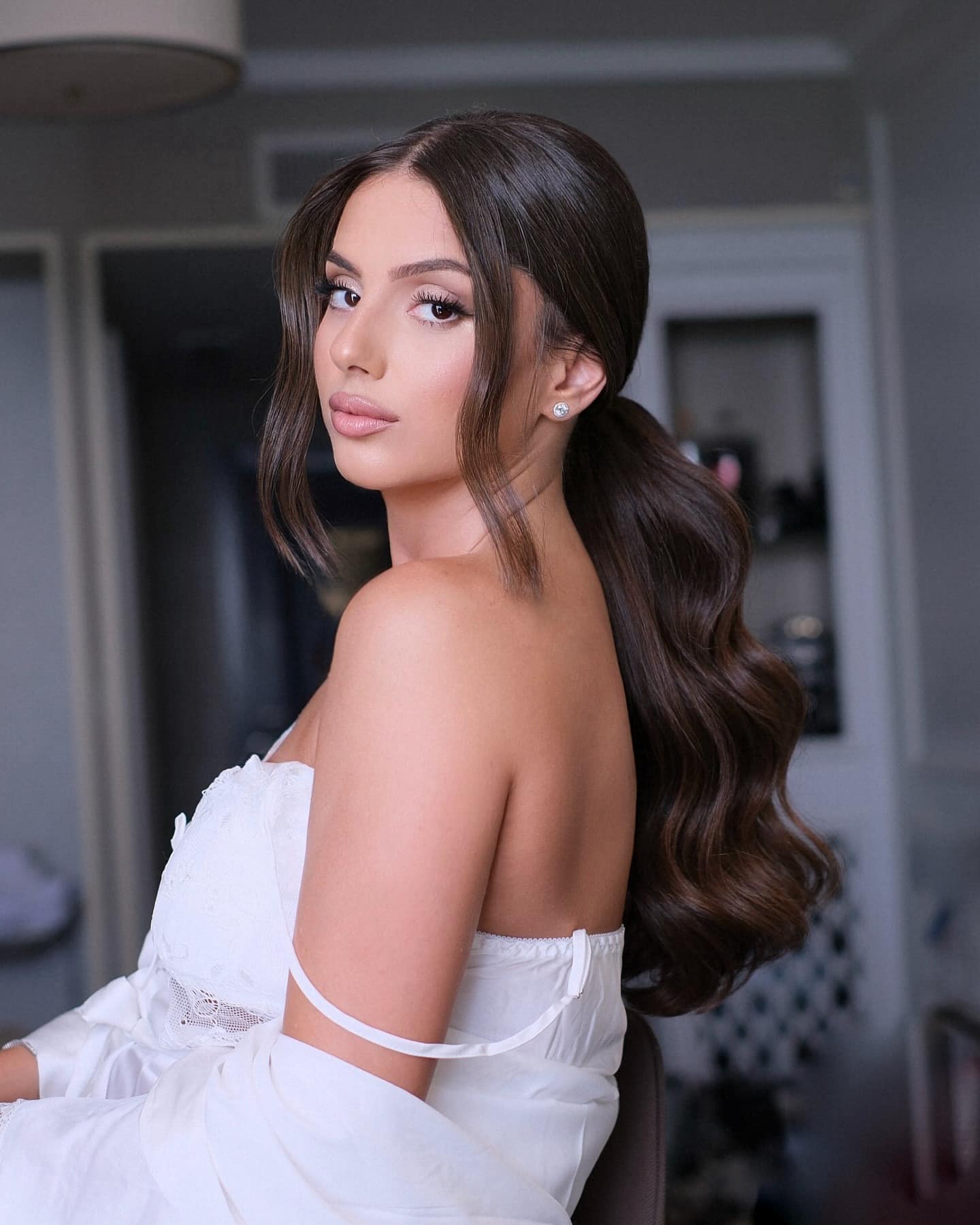 22. Low Sleek Ponytail with Center Part β Glossy Espresso Brown - Bride Hairstyles