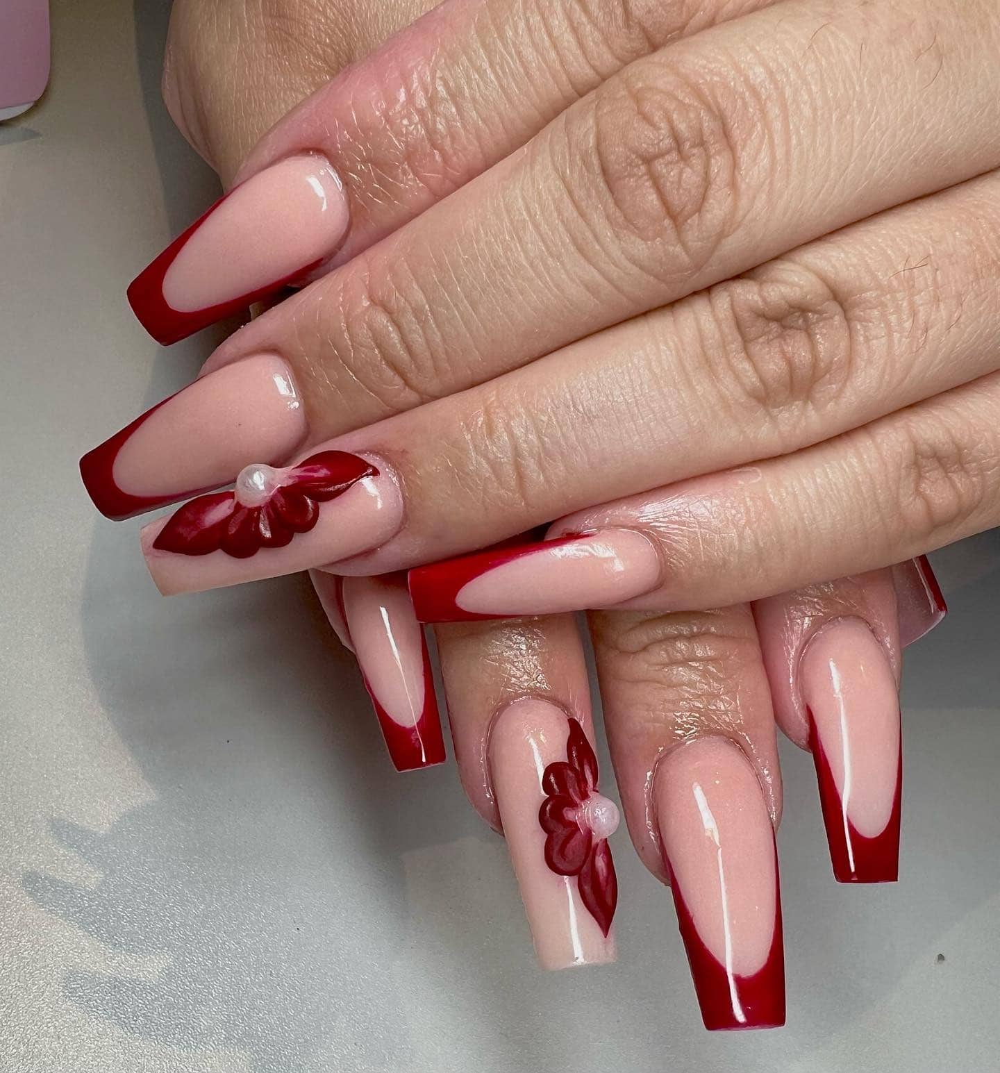 11. Red French Tips with 3D Floral Accents - red french tip nail ideas