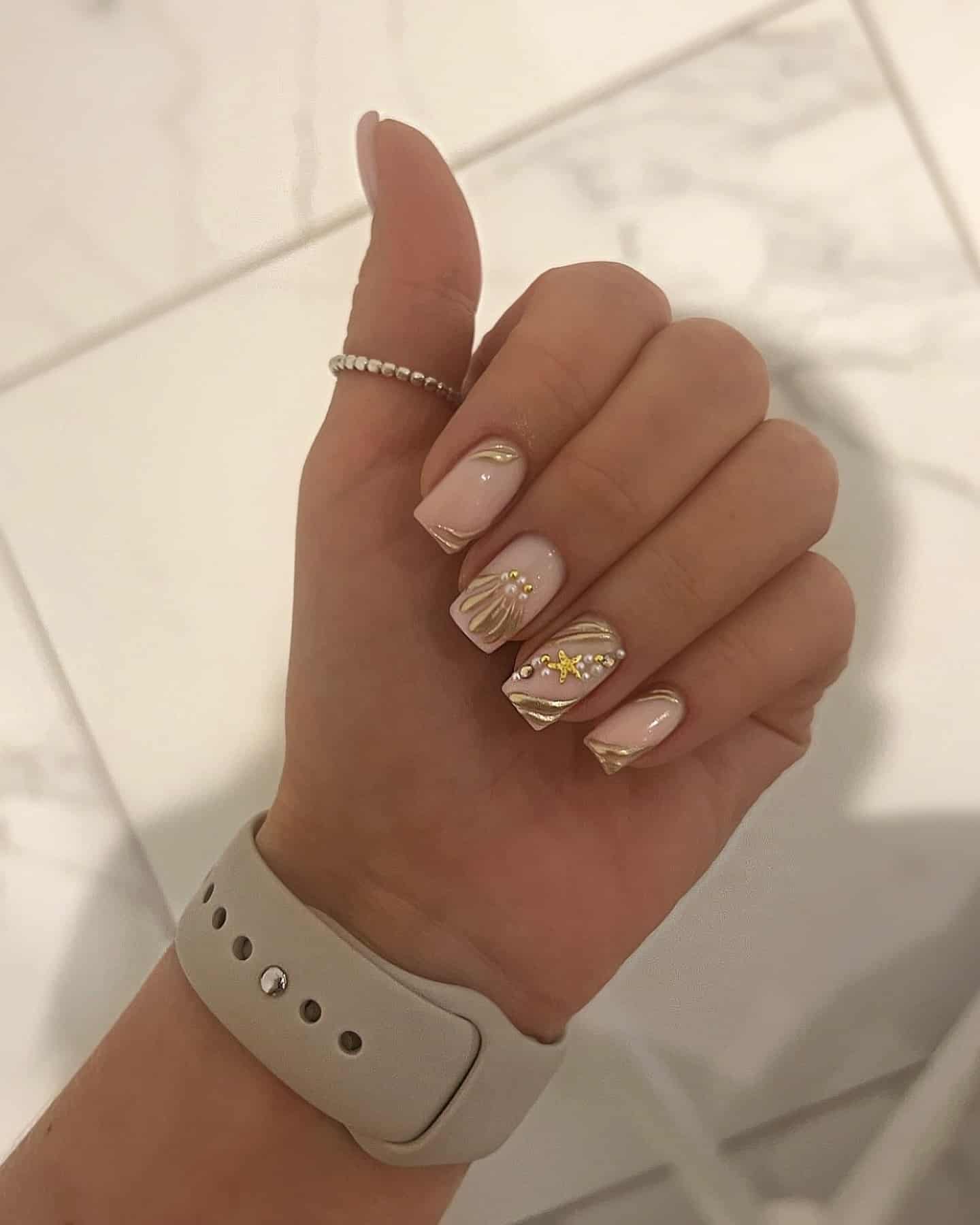 12. Golden Seashell Accents - shell nail ideas