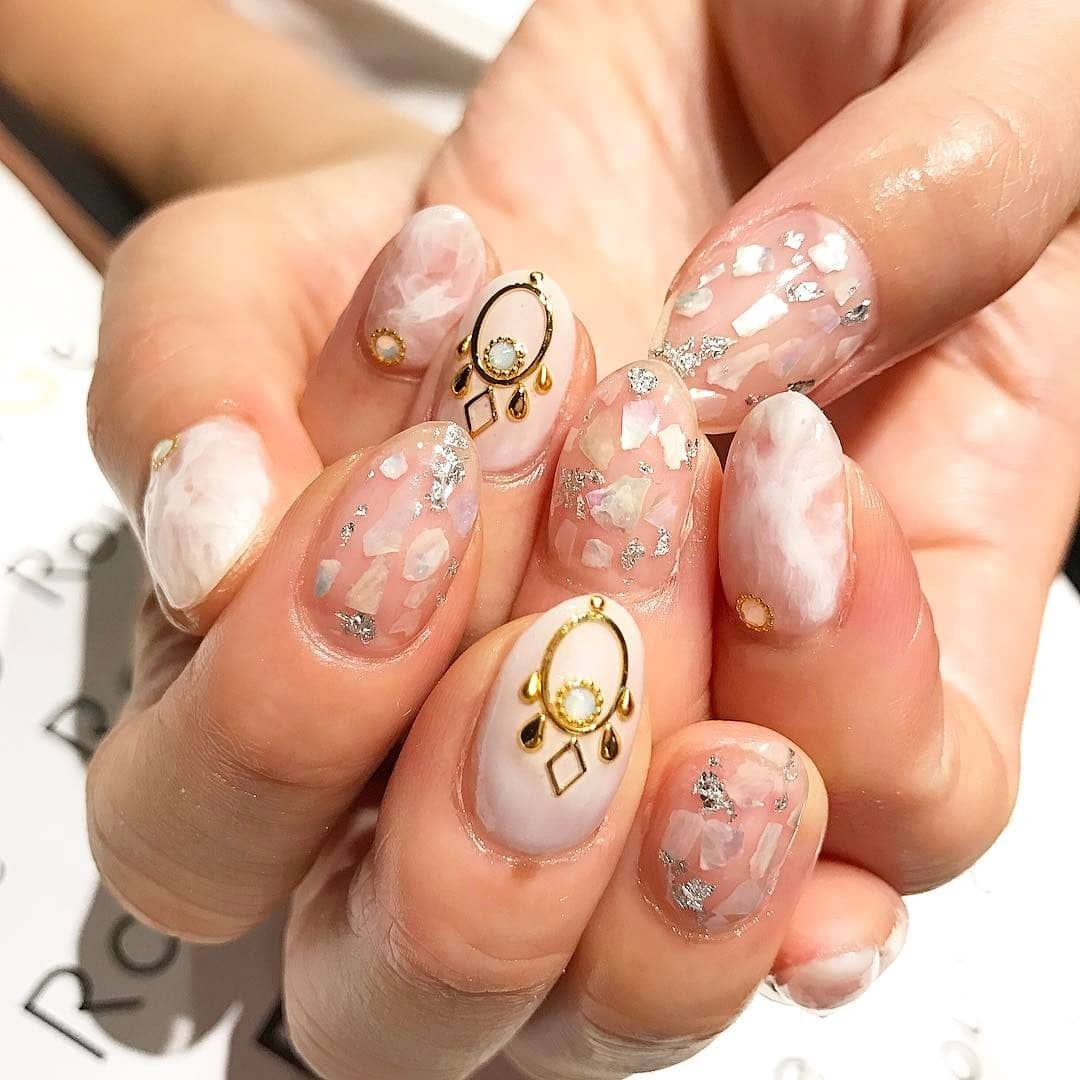 14. Iridescent Shell Treasure - shell nail ideas