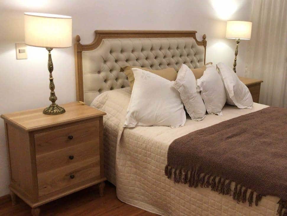 12. Oak Elegance with Tufted Upholstery - oak bedroom ideas