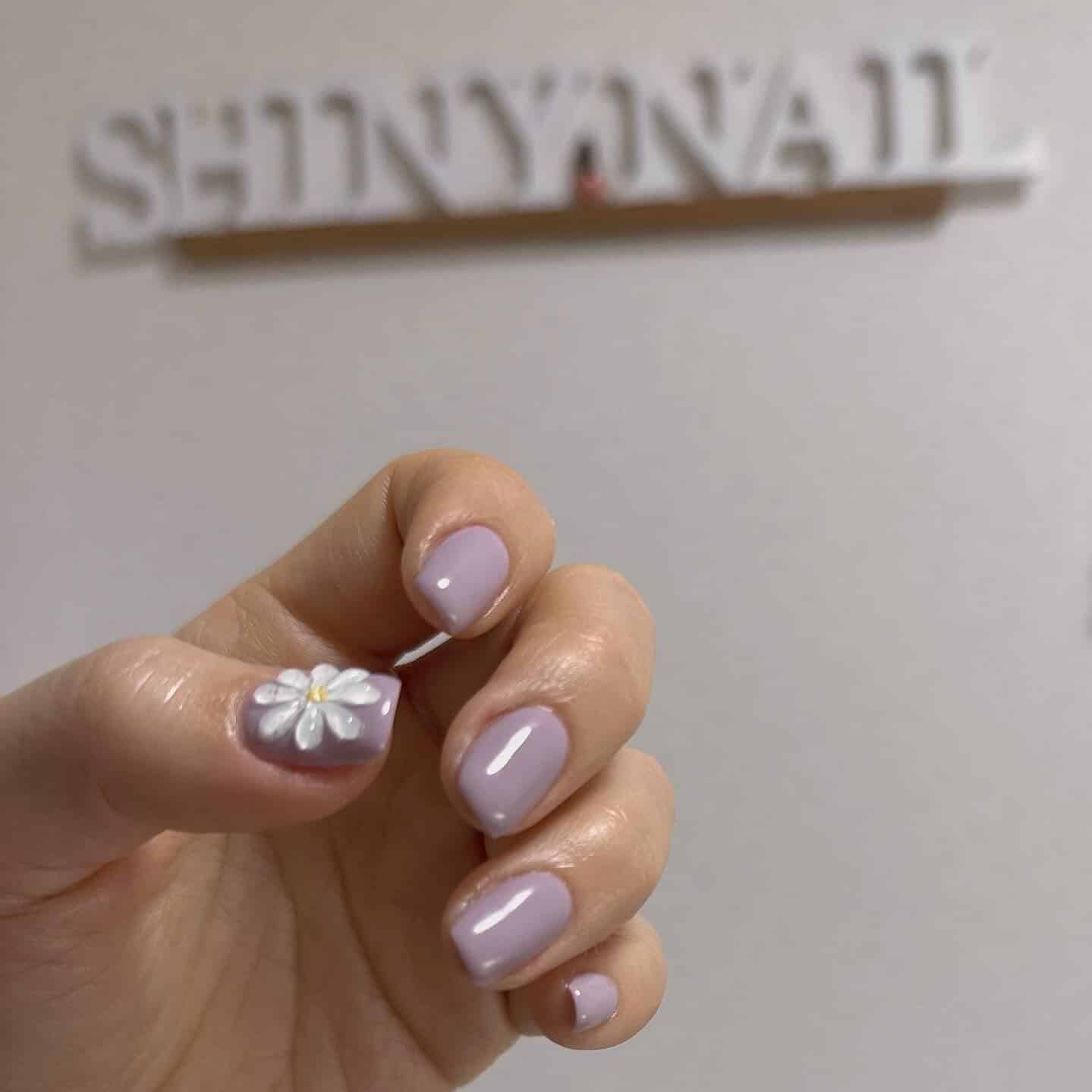 22. Soft Lavender with Daisy Accent - shiny nail ideas