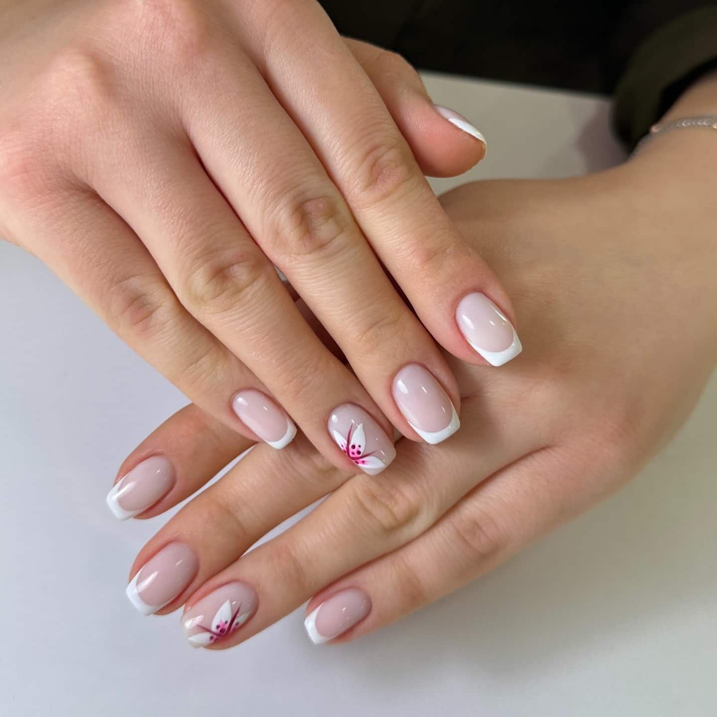 8. French with Floral Accent - short french nail ideas