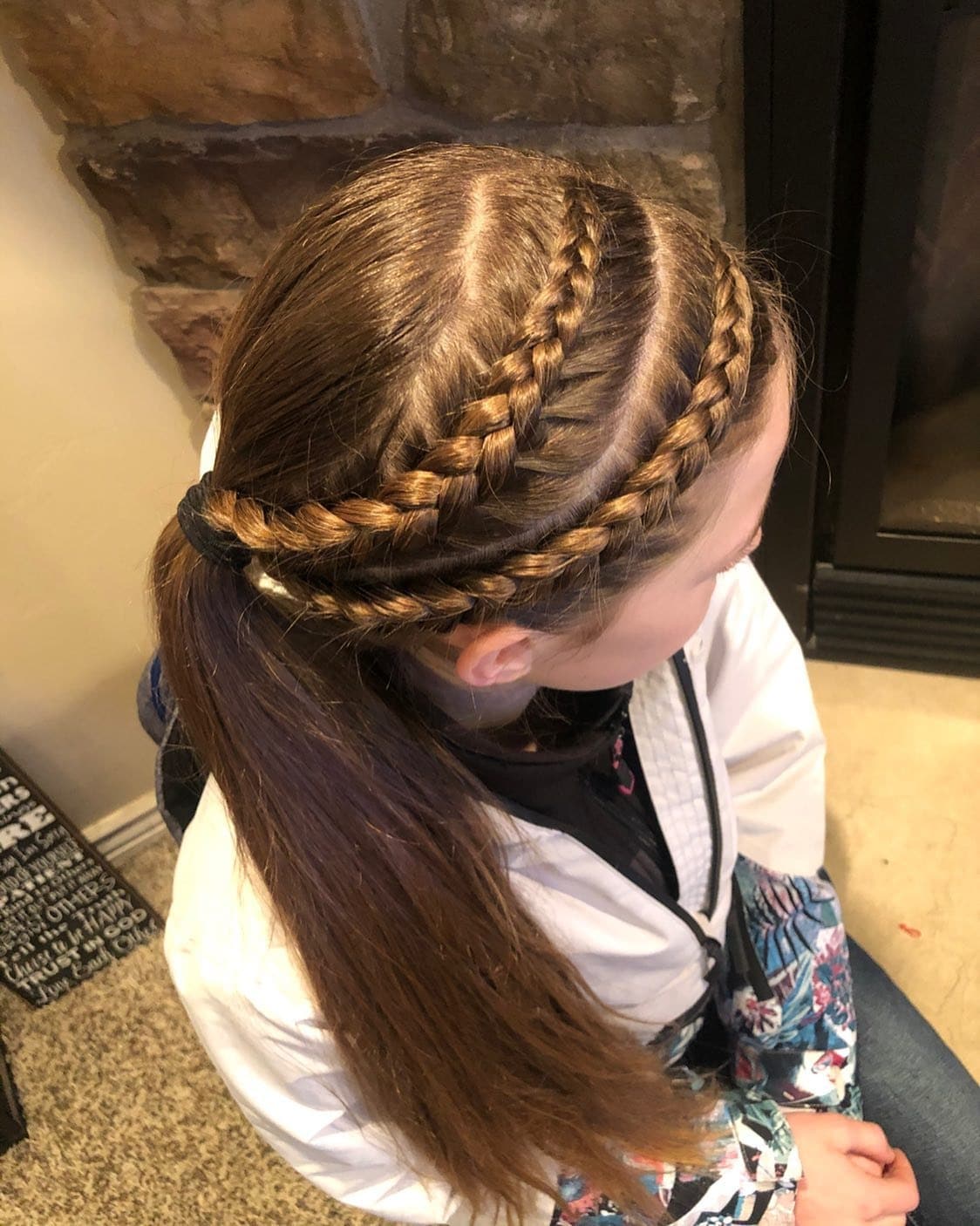 3. Side-Swept Braided Crown into Ponytail on Chestnut Hair - Volleyball Hairstyles