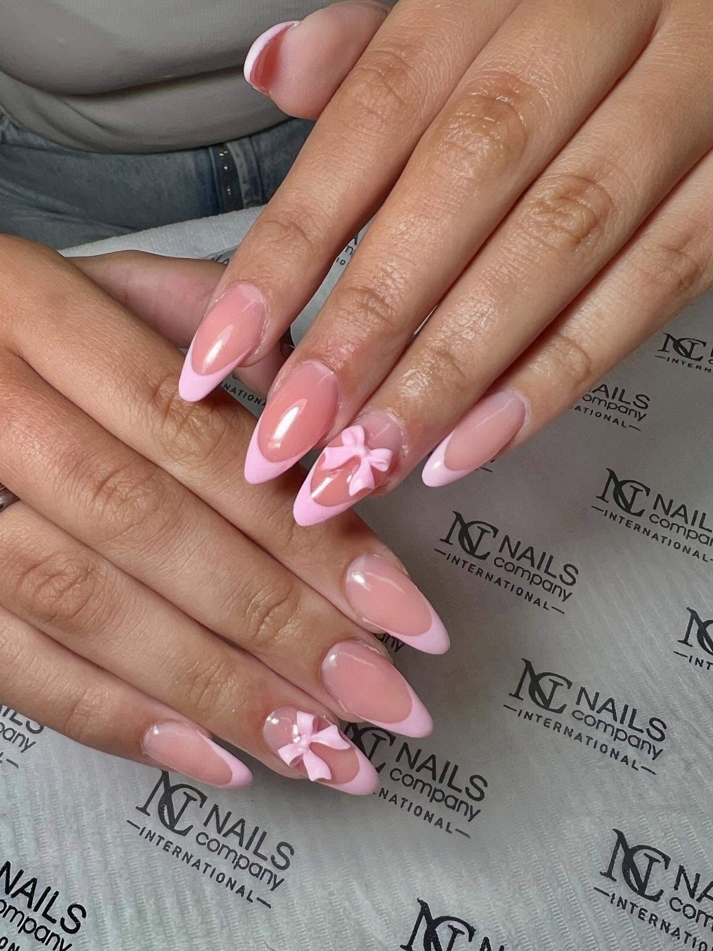7. Pink French Almonds with 3D Bow Accents - short pink nail ideas