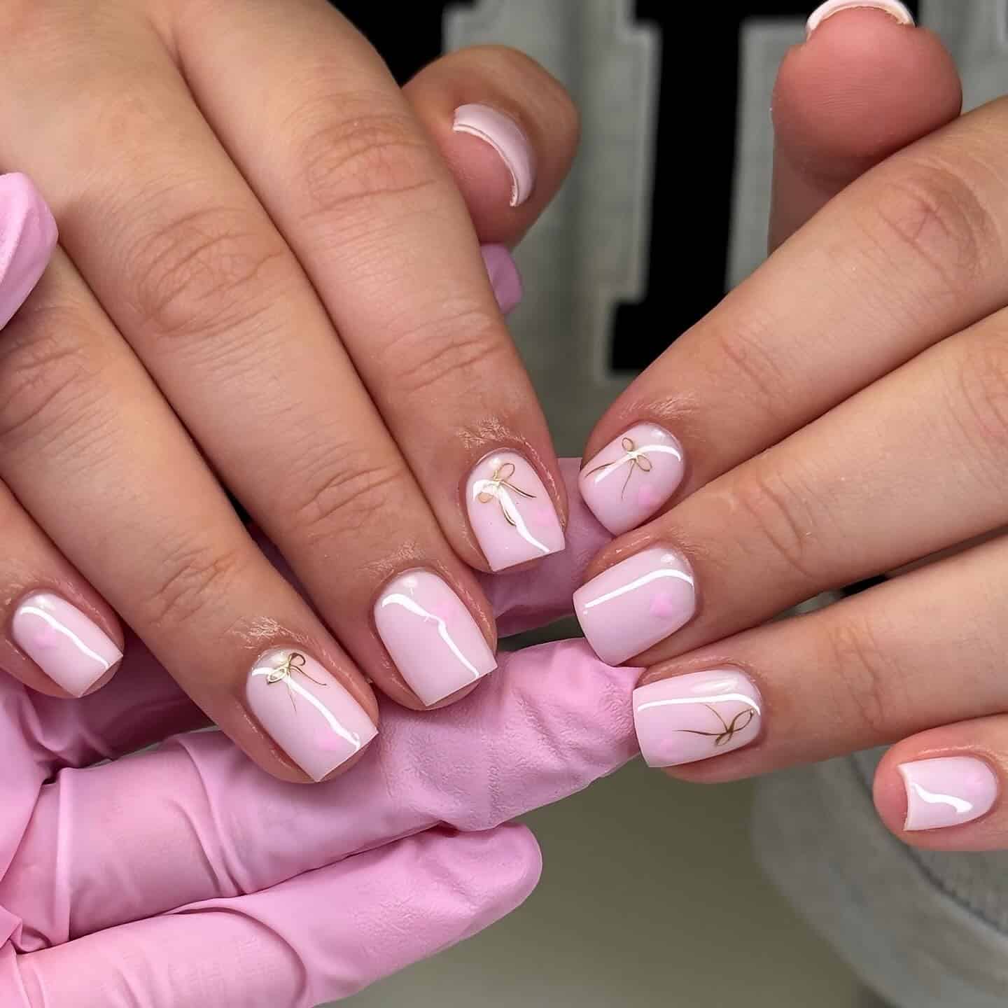 10. Short Pink with Golden Ribbon Details - short pink nail ideas
