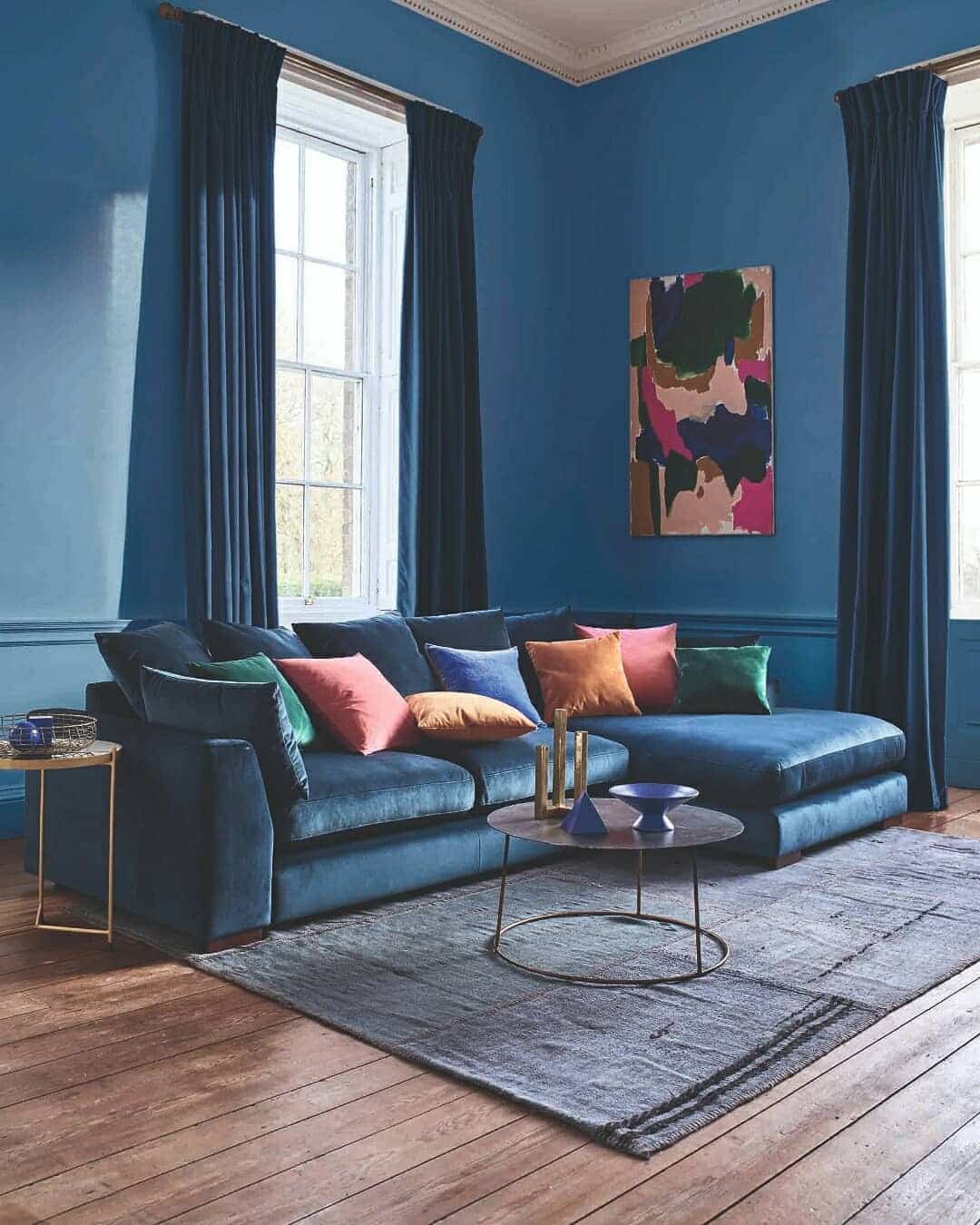 1. Bold Contrast with Jewel Accents - navy blue living room ideas