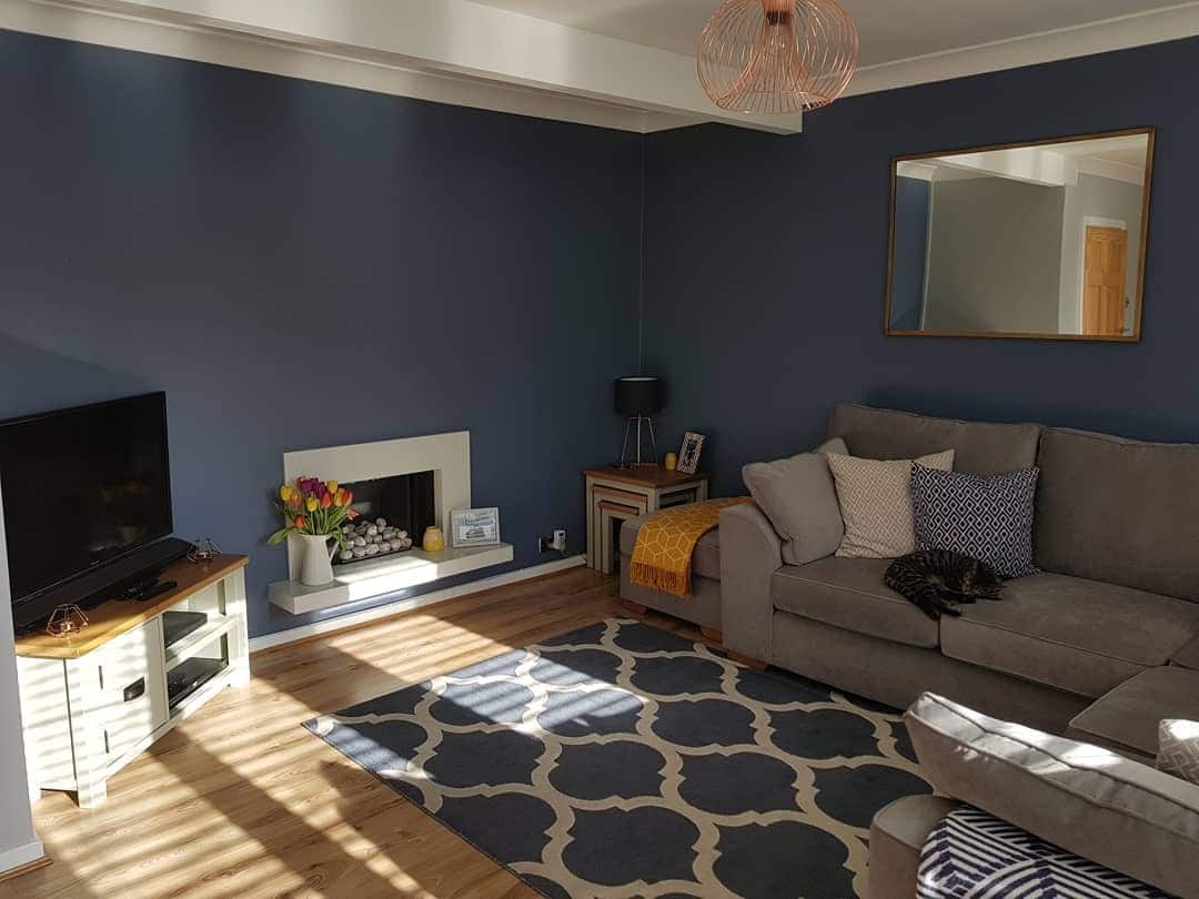 7. Casual Comfort with Warm Accents - navy blue living room ideas