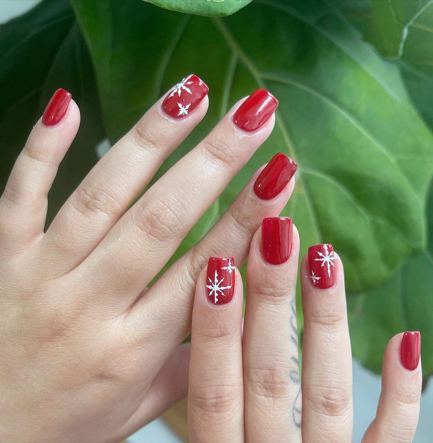 16. Glossy Red with Star Accents - simple short square nail ideas