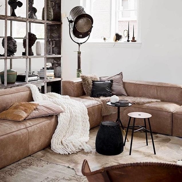 21. Industrial Masculine Comfort with Leather and Sculptural Accents - masculine living room ideas