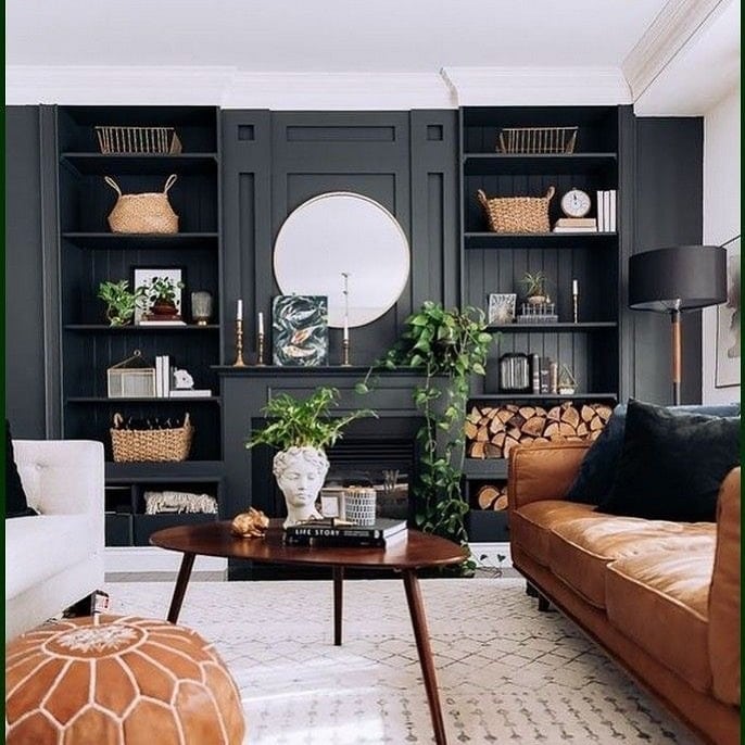 12. Layered Shelving with Warm Leather Accents - brown and black living room ideas