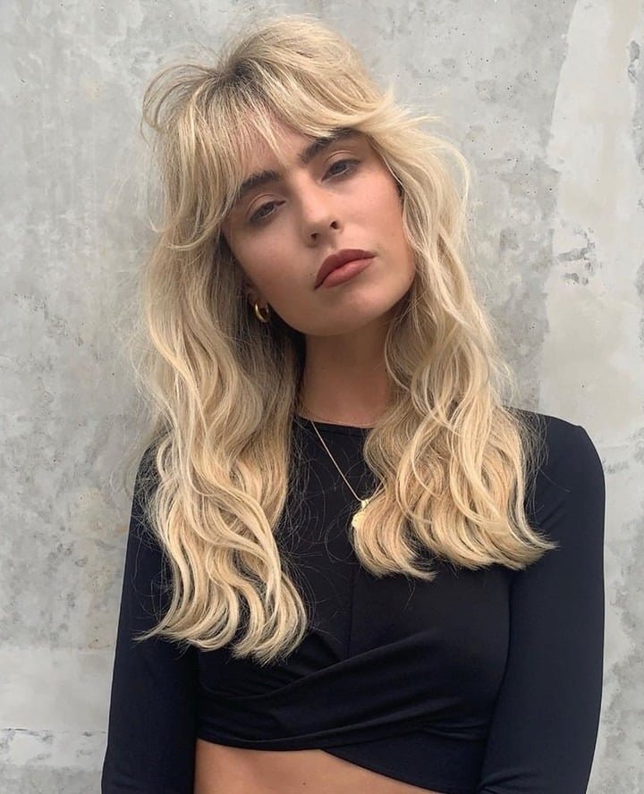 4. Voluminous Blonde Shag with Curtain Bangs - 70S Hairstyles