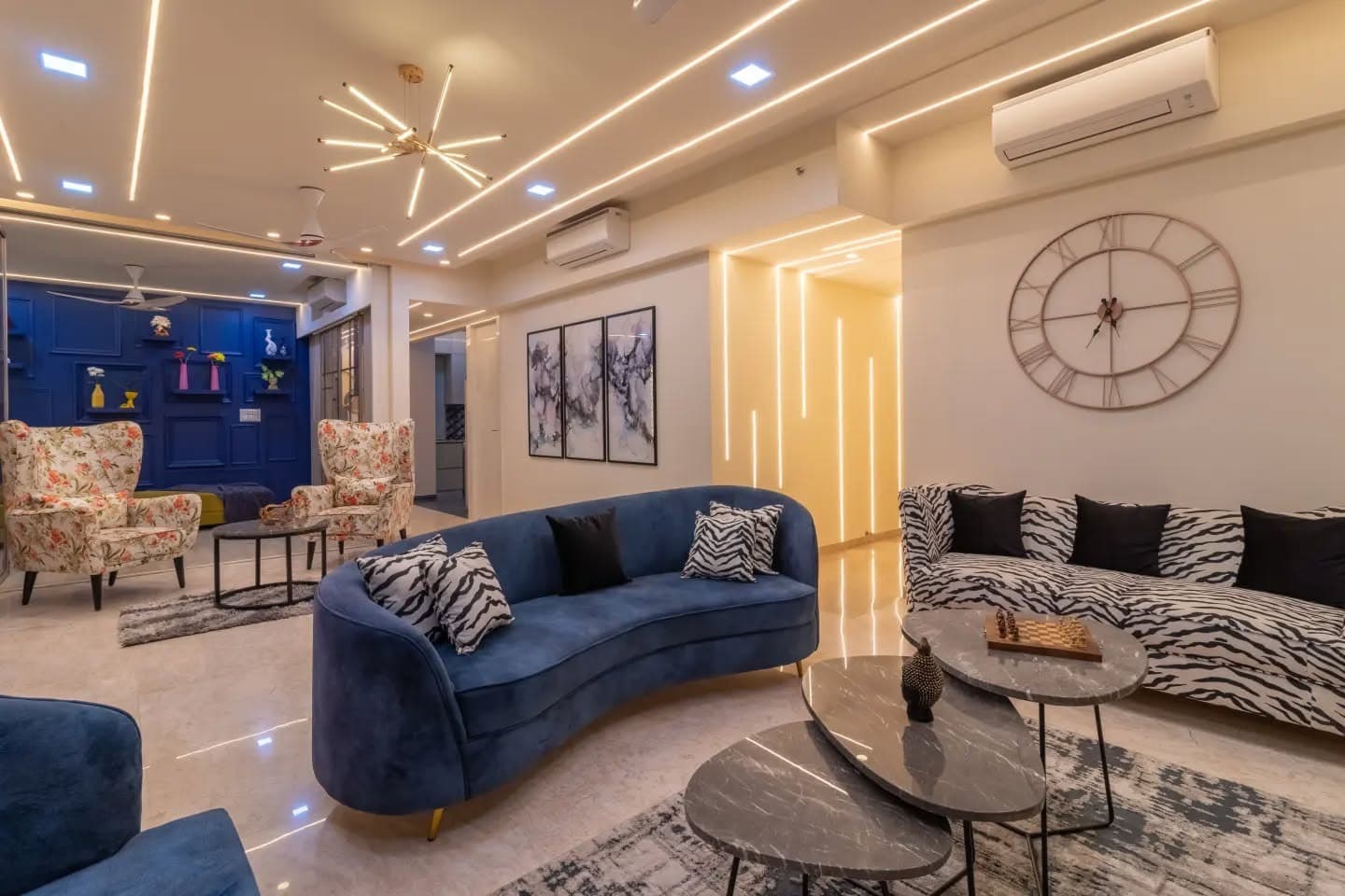 3. Playful Contemporary with Blue Curves - black and blue living room ideas