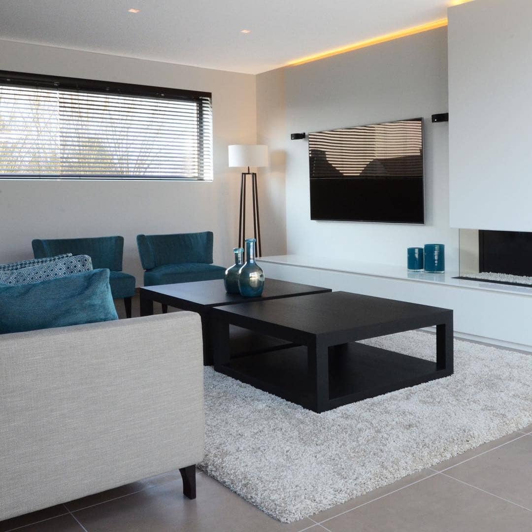 8. Clean Contemporary with Teal Accents - black and blue living room ideas