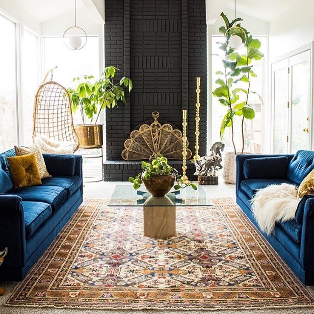 15. Eclectic Charm with Blue Sofas and Black Fireplace - black and blue living room ideas