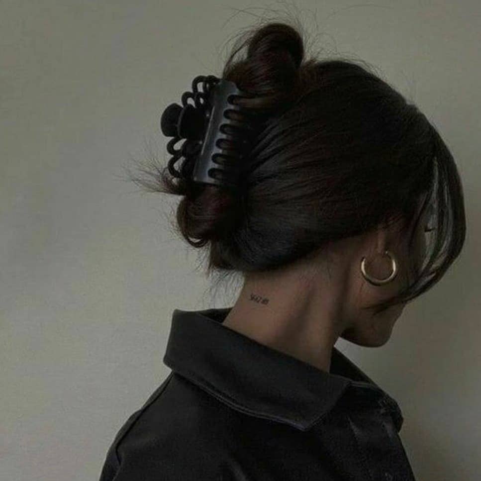 4. Elegant Low Twist with Black Matte Clip on Dark Hair - Claw Clip Hairstyles