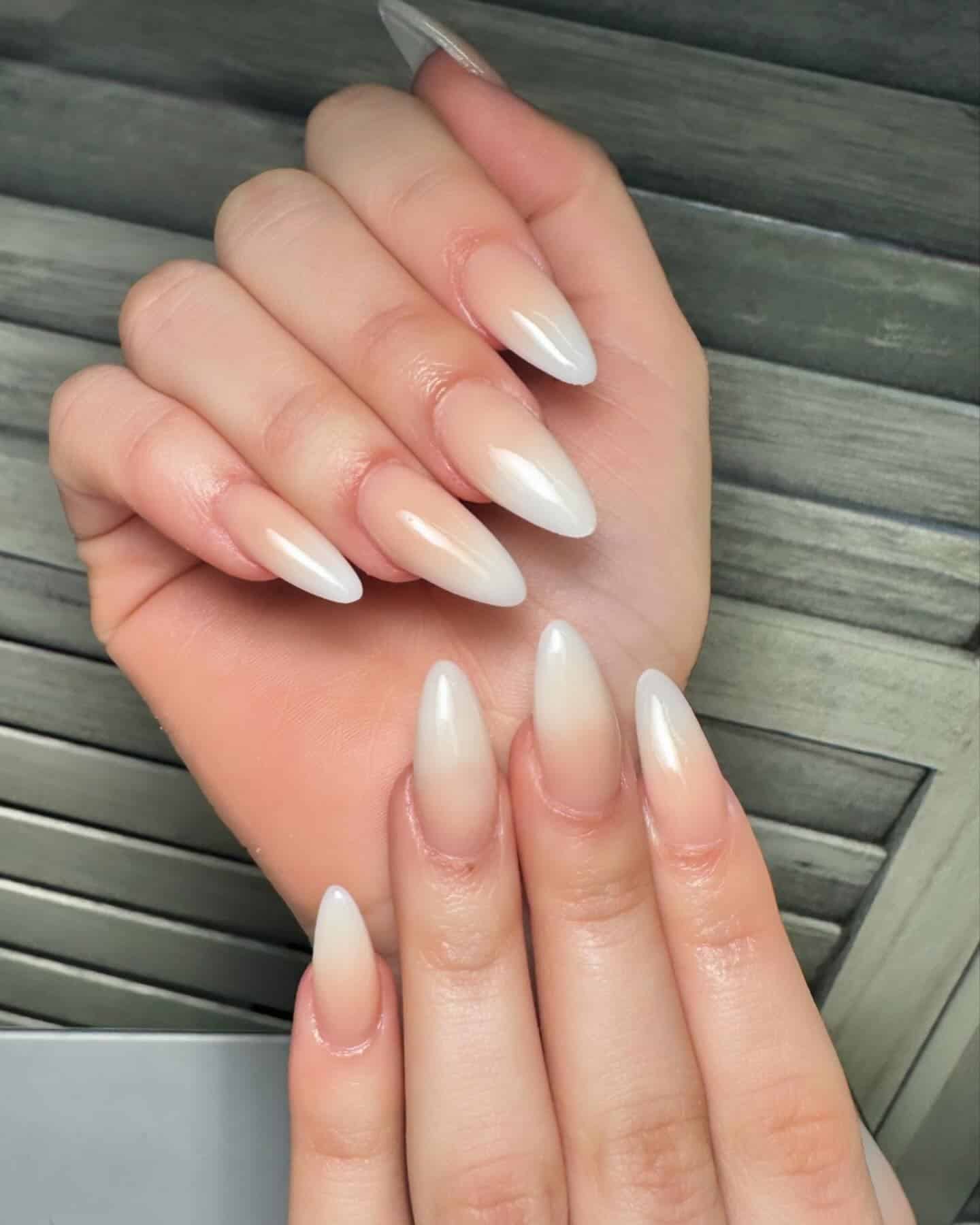 16. Stiletto Creamy Fade - white ombre nail ideas