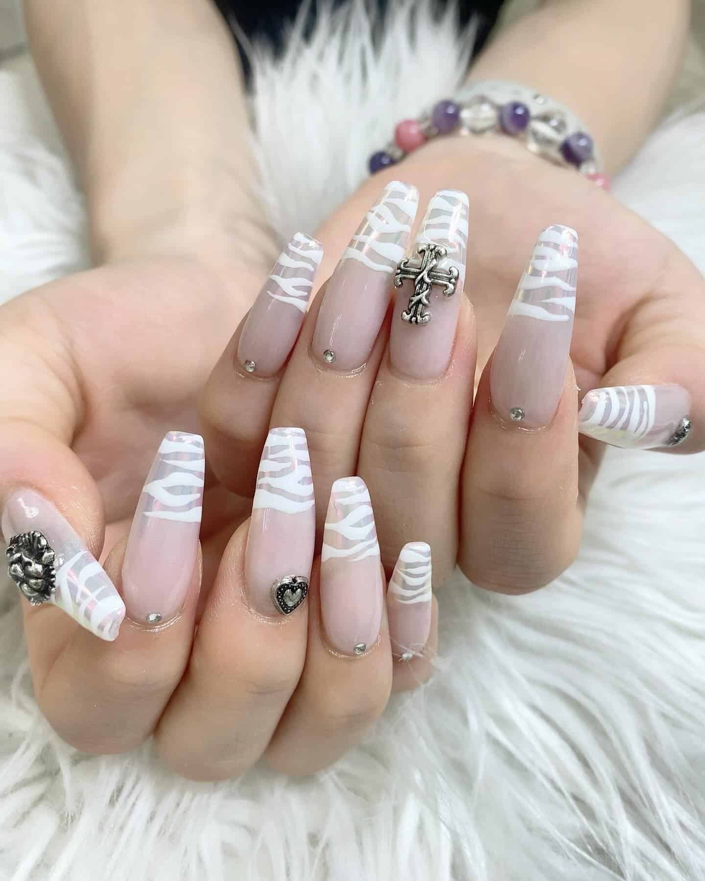 12. White Zebra French with Metallic Charms - zebra nail ideas