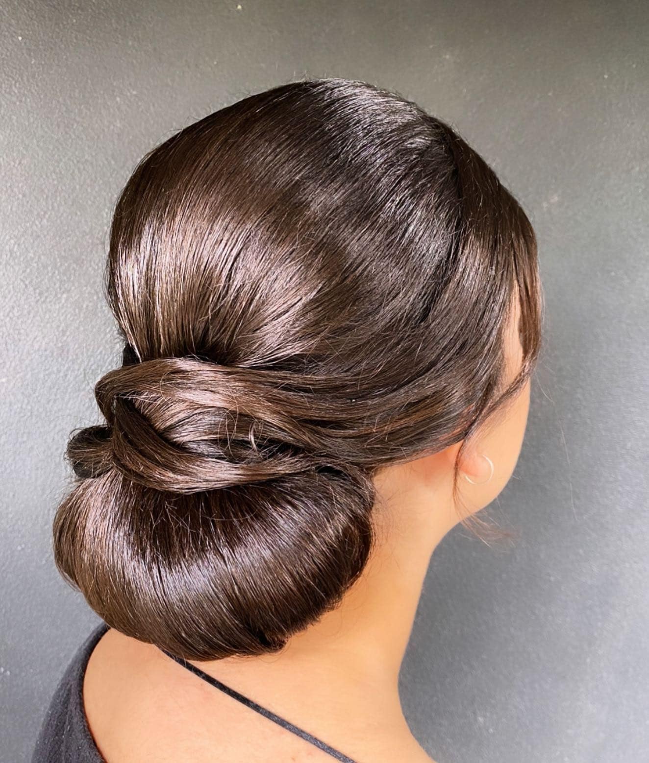 15. Classic Low Bun Twist on Dark Chocolate Brown - Formal Hairstyles